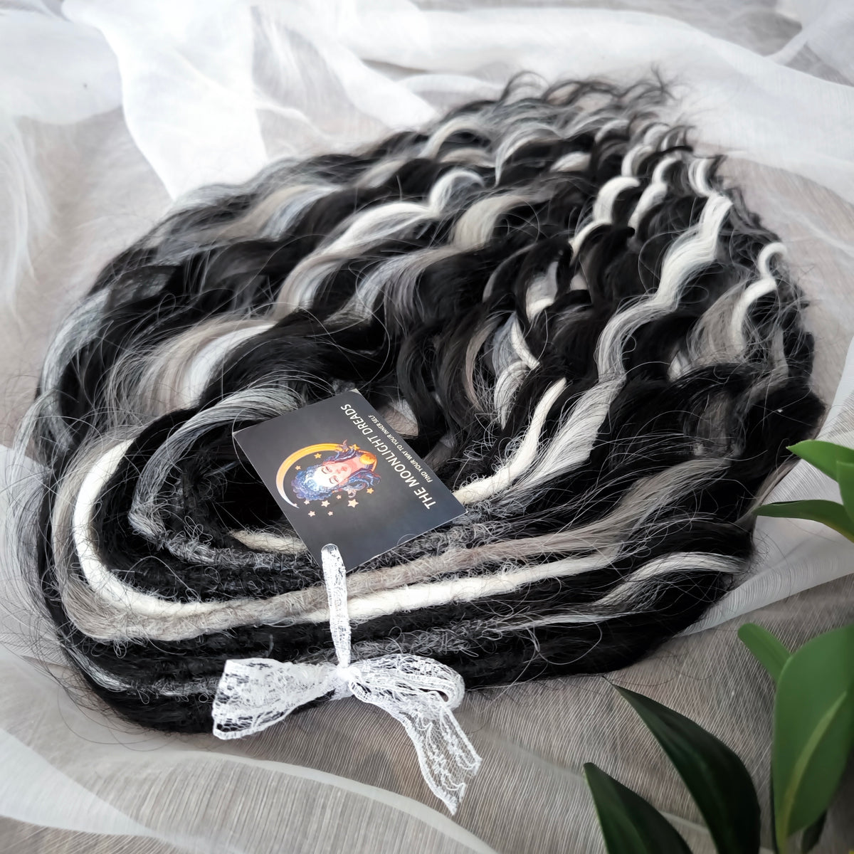 Silver Raven - 50 double ended ready-to-ship black, silver-grey, and white synthetic brushable wavy dreadlocks. Soft, lightweight, and reusable, a monochromatic blend with a dark, mysterious, witchy feel. Your spooky season look starts here

