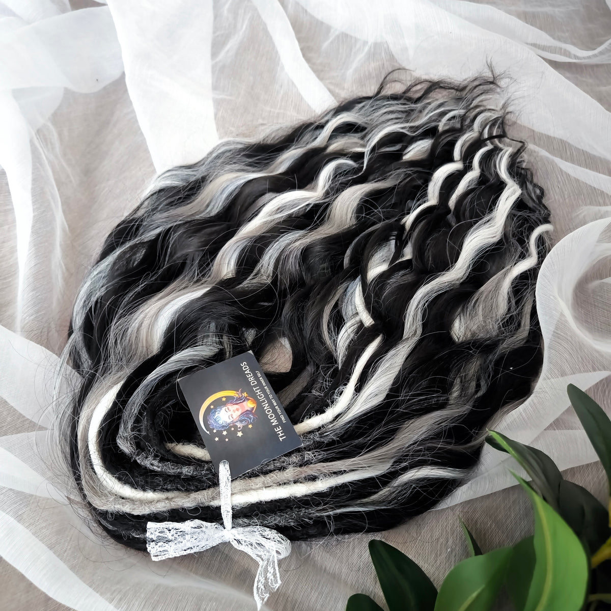 Silver Raven - 50 double ended ready-to-ship black, silver-grey, and white synthetic brushable wavy dreadlocks. Soft, lightweight, and reusable, a monochromatic blend with a dark, mysterious, witchy feel. Your spooky season look starts here
