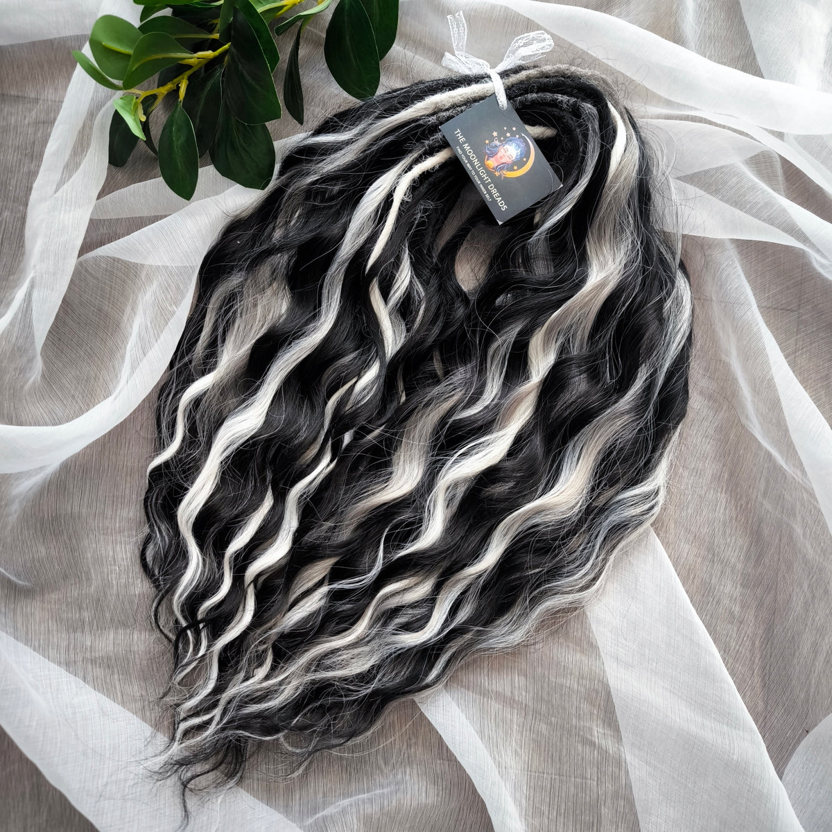 Silver Raven - 50 double ended ready-to-ship black, silver-grey, and white synthetic brushable wavy dreadlocks. Soft, lightweight, and reusable, a monochromatic blend with a dark, mysterious, witchy feel. Your spooky season look starts here