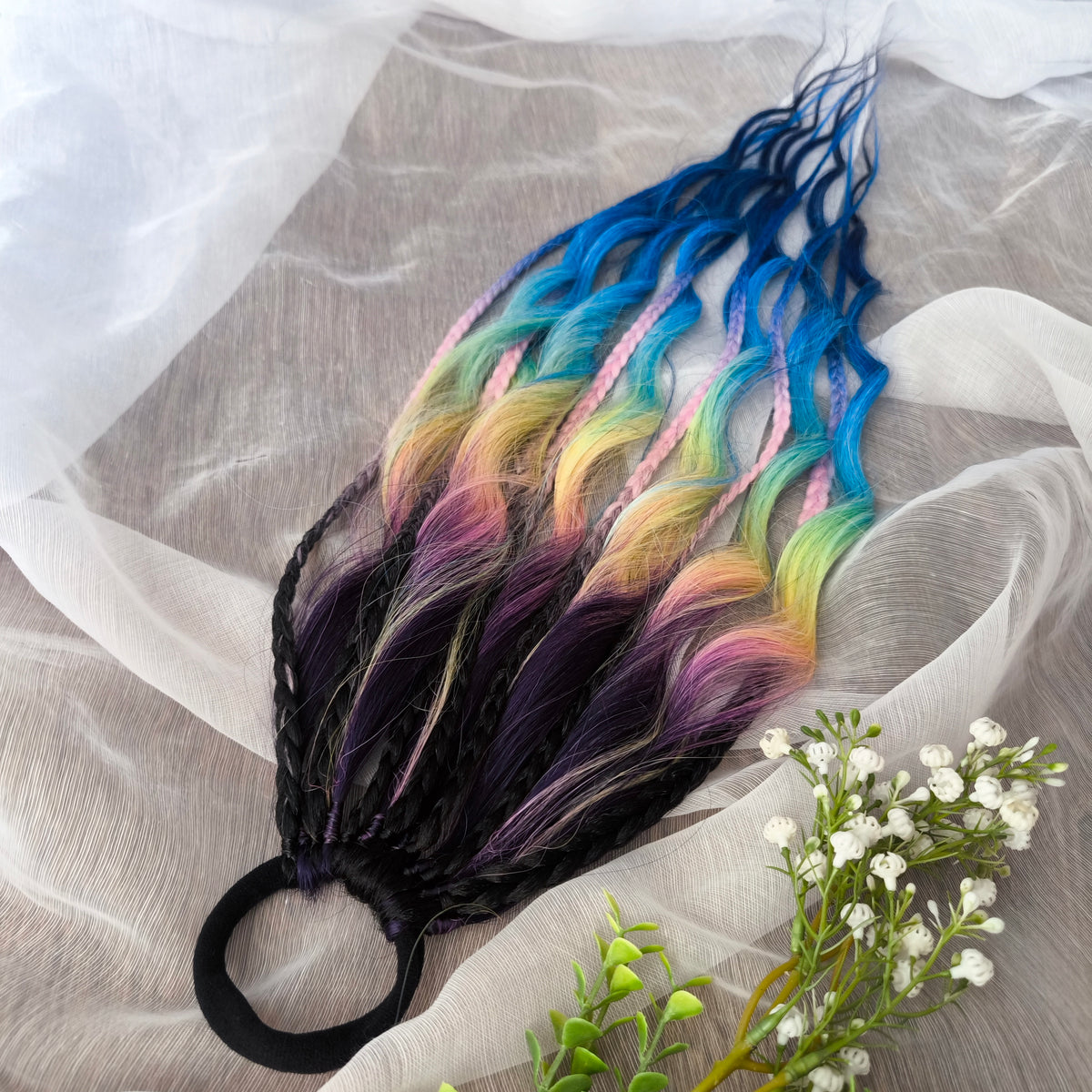 Gradient from deep purple to yellow, pink, and blue braids and curls on an elastic band — a simple way to transform a ponytail without installing a set. Easy to put on and remove whenever you like. A great option if you can’t install dreads or braids. Also, a perfect gift for kids