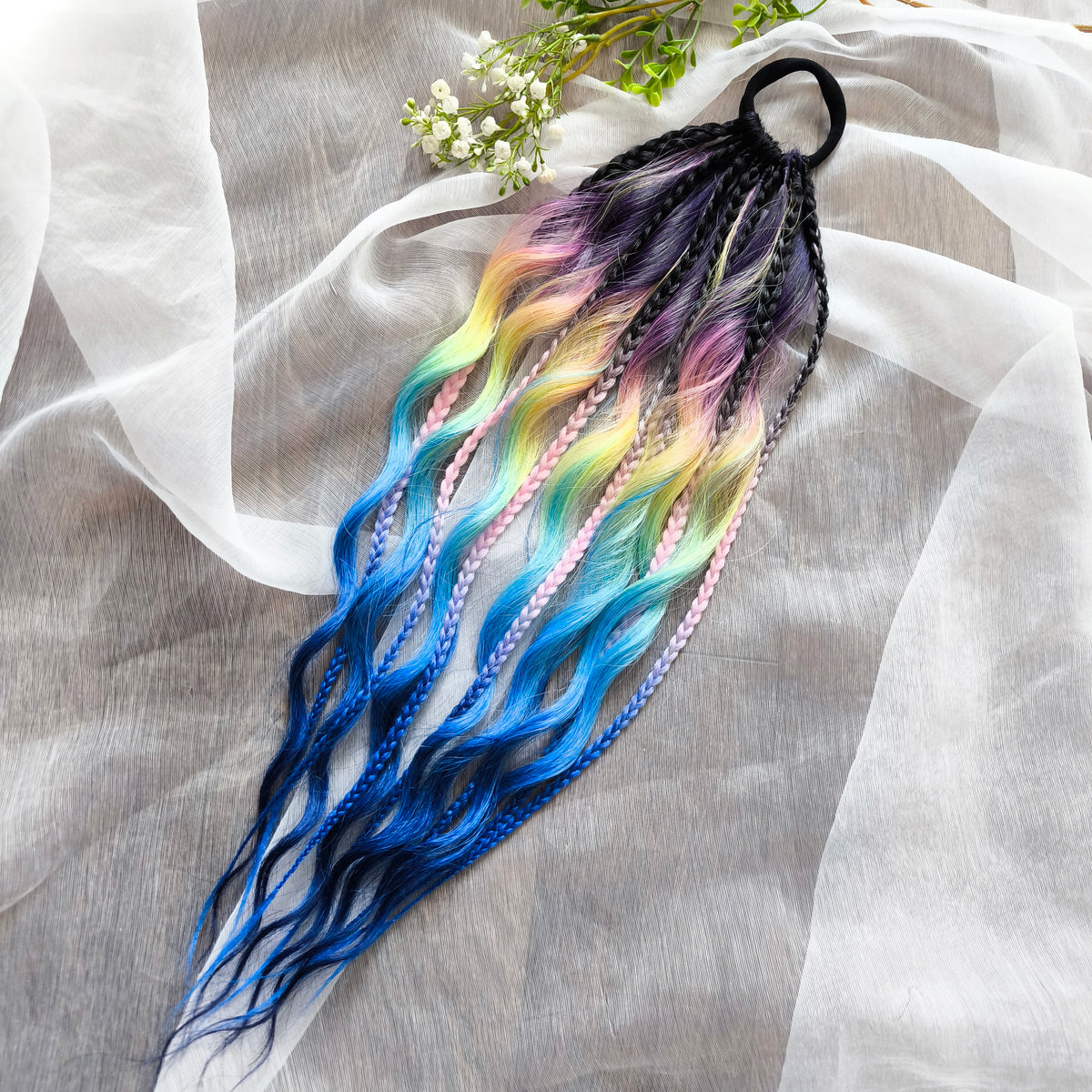 Gradient from deep purple to yellow, pink, and blue braids and curls on an elastic band — a simple way to transform a ponytail without installing a set. Easy to put on and remove whenever you like. A great option if you can’t install dreads or braids. Also, a perfect gift for kids