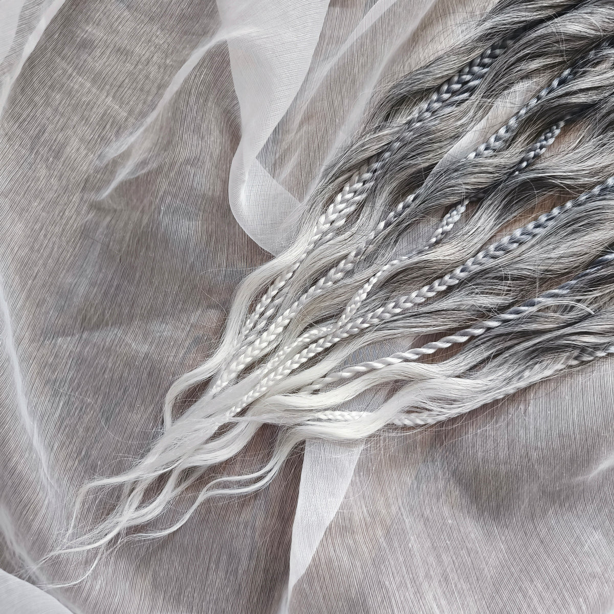 Grey, black, and white braids and curls on an elastic band — a simple way to transform a ponytail without installing a set