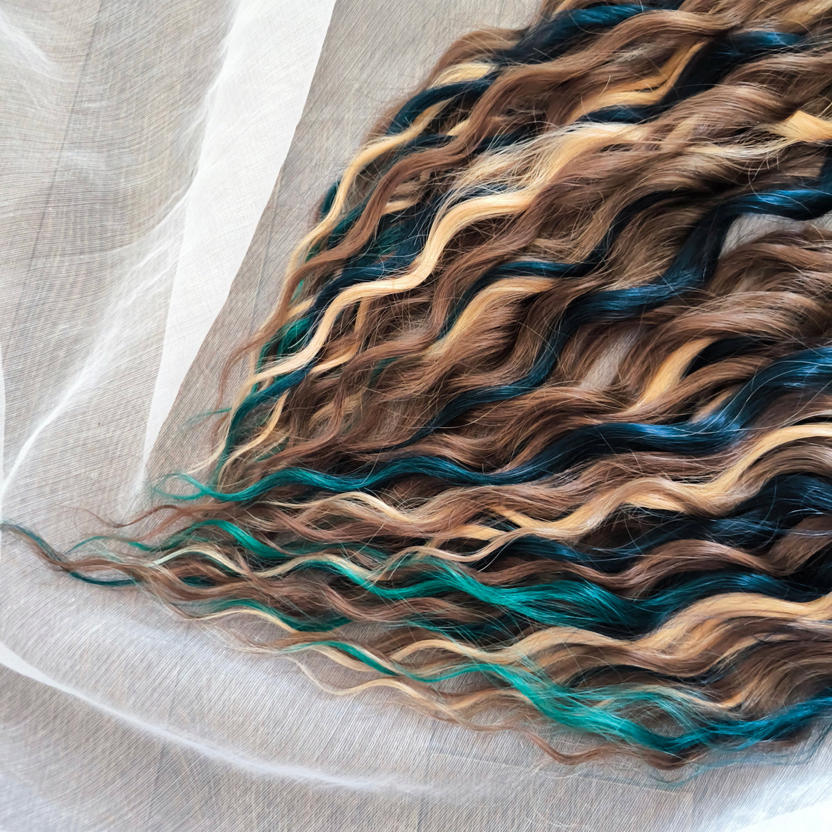 Sylvan - 50 double ended ready-to-ship warm brown, golden blonde, midnight teal synthetic brushable wavy dreadlocks. Soft, lightweight, and reusable, woodland-inspired blend with a touch of dark, mysterious magic.