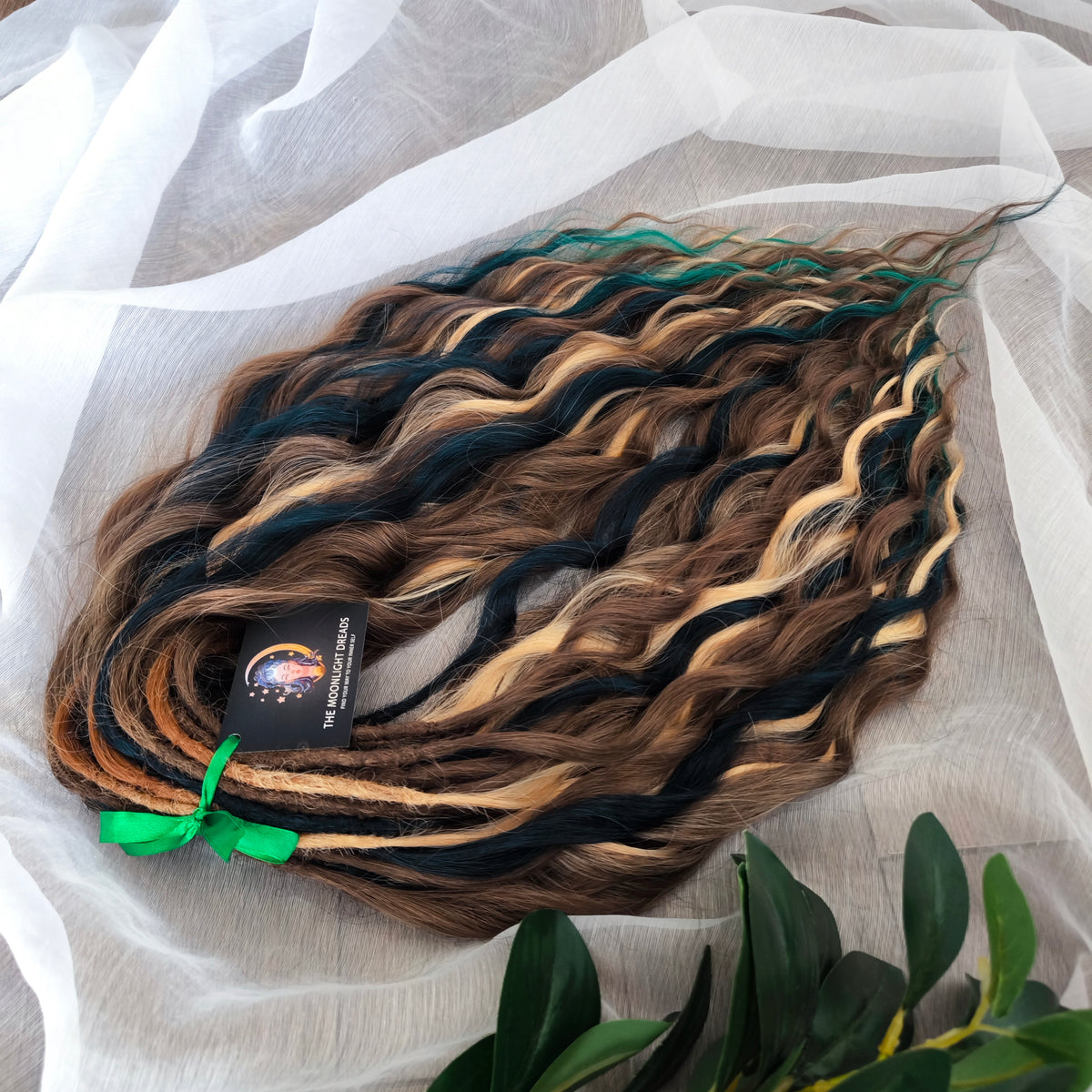 Sylvan - 50 double ended ready-to-ship warm brown, golden blonde, midnight teal synthetic brushable wavy dreadlocks. Soft, lightweight, and reusable, woodland-inspired blend with a touch of dark, mysterious magic.