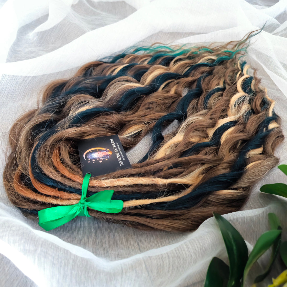 Sylvan - 50 double ended ready-to-ship warm brown, golden blonde, midnight teal synthetic brushable wavy dreadlocks. Soft, lightweight, and reusable, woodland-inspired blend with a touch of dark, mysterious magic.