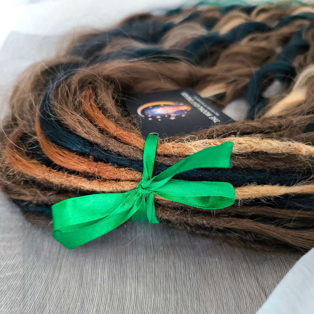 Sylvan - 50 double ended ready-to-ship warm brown, golden blonde, midnight teal synthetic brushable wavy dreadlocks. Soft, lightweight, and reusable, woodland-inspired blend with a touch of dark, mysterious magic.