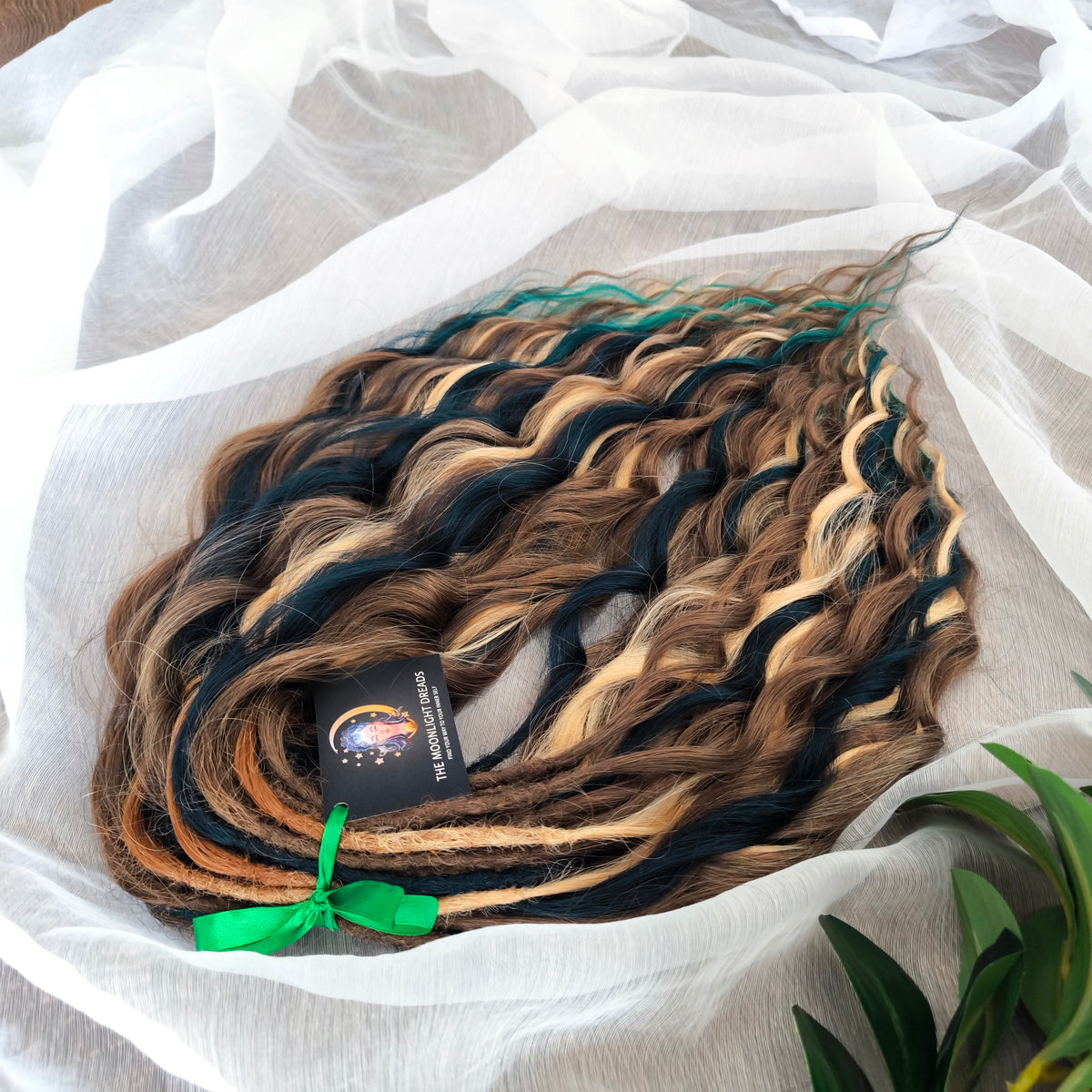 Sylvan - 50 double ended ready-to-ship warm brown, golden blonde, midnight teal synthetic brushable wavy dreadlocks. Soft, lightweight, and reusable, woodland-inspired blend with a touch of dark, mysterious magic.