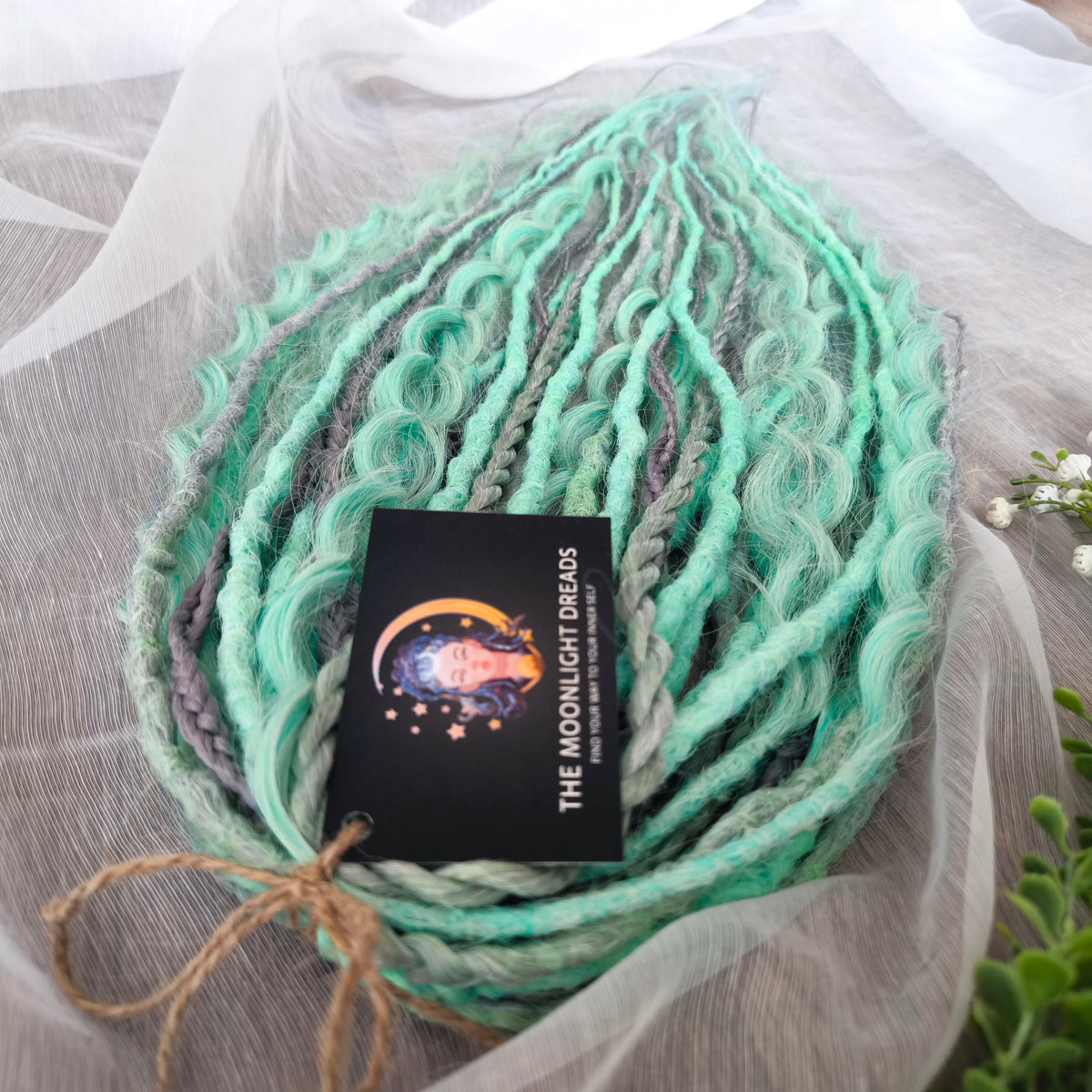 Silver Mint: soft, lightweight, and reusable 20 double ended synthetic crochet dreadlocks, braids, and non-brushable curls in a soft blend of silver and aquamarine.
