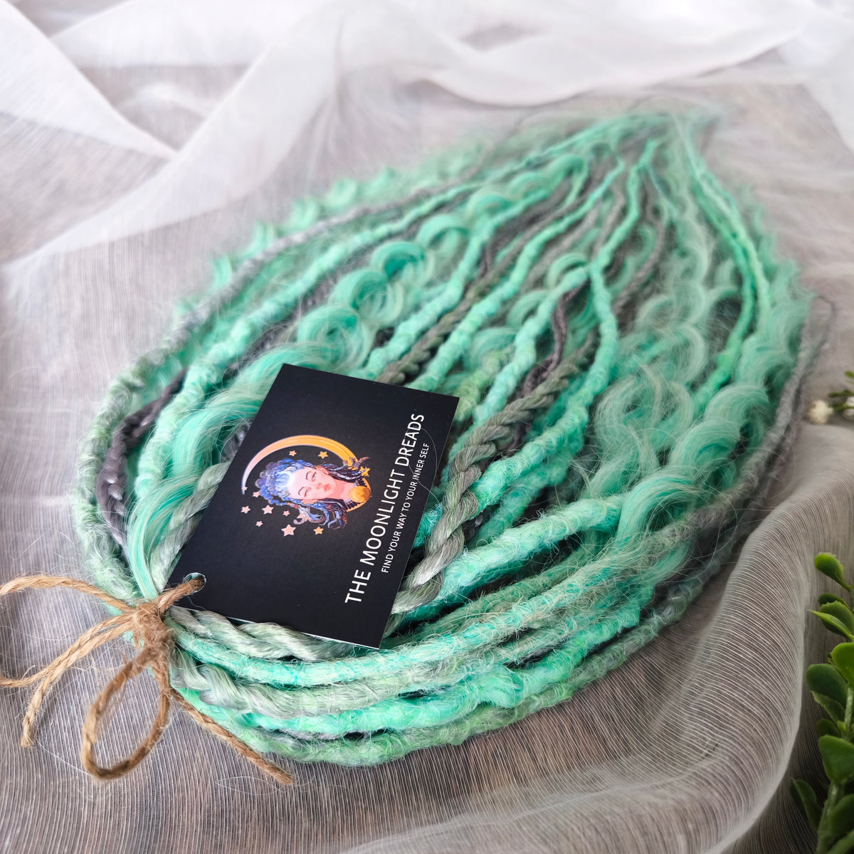 Silver Mint: soft, lightweight, and reusable 20 double ended synthetic crochet dreadlocks, braids, and non-brushable curls in a soft blend of silver and aquamarine.
