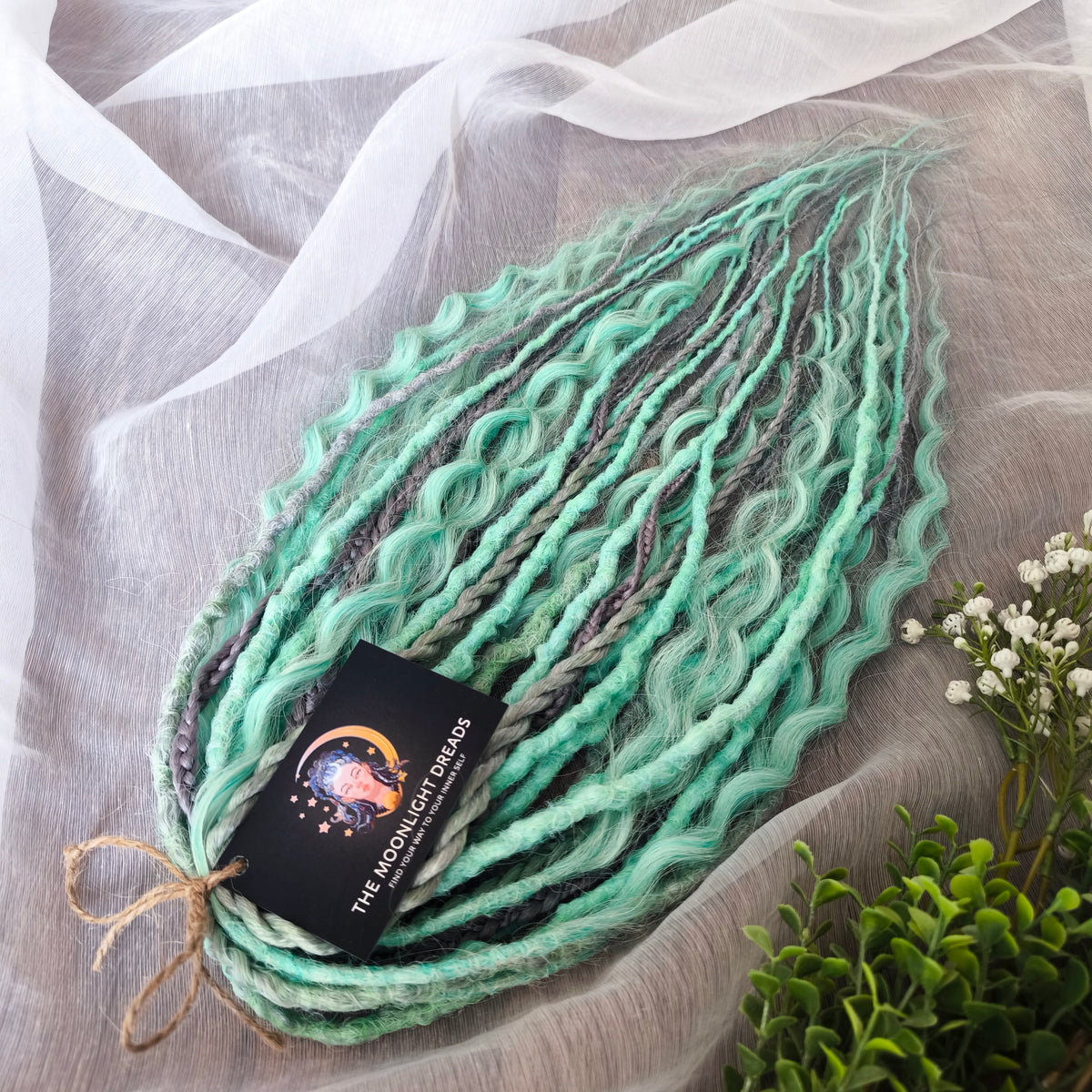Silver Mint: soft, lightweight, and reusable 20 double ended synthetic crochet dreadlocks, braids, and non-brushable curls in a soft blend of silver and aquamarine.
