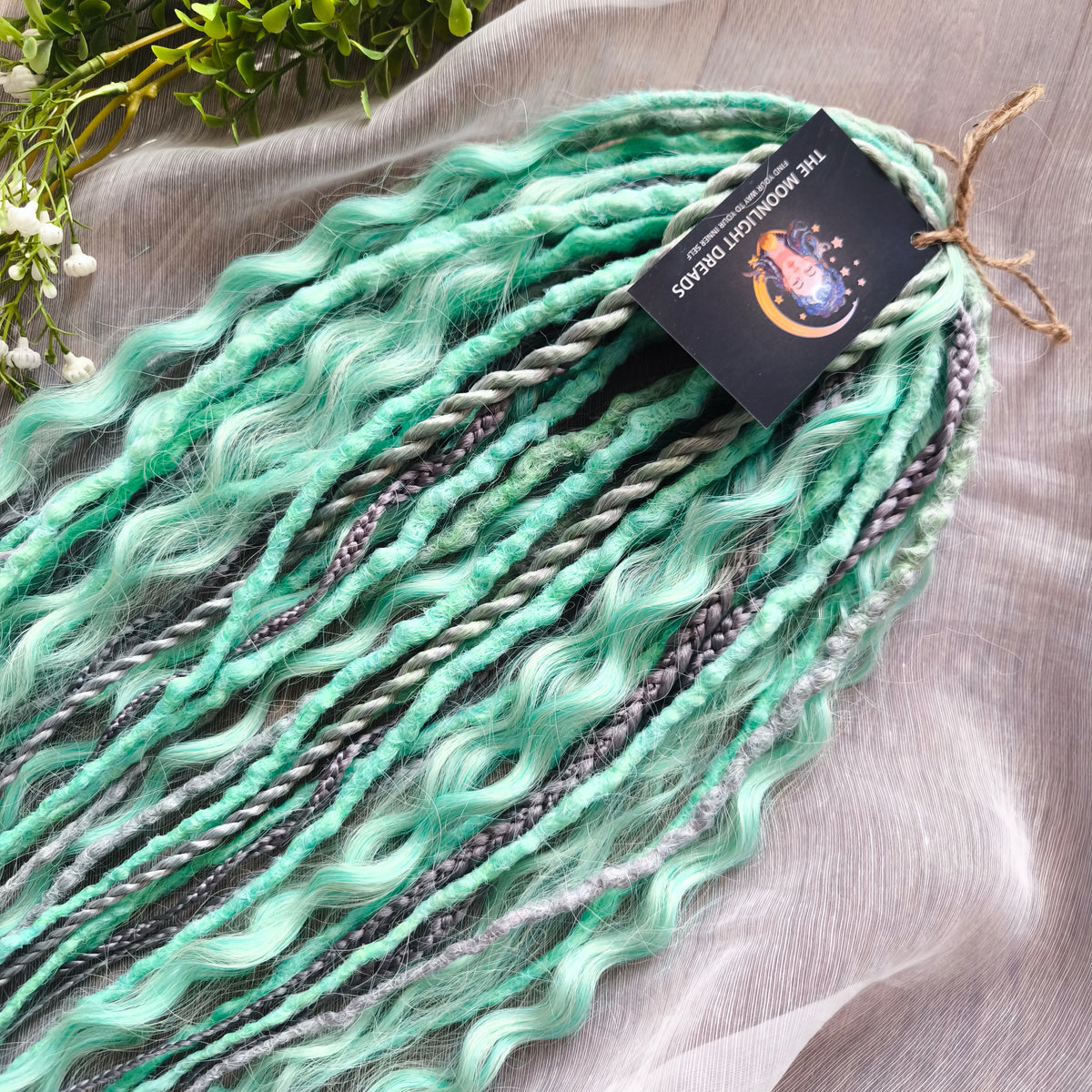Silver Mint: soft, lightweight, and reusable 20 double ended synthetic crochet dreadlocks, braids, and non-brushable curls in a soft blend of silver and aquamarine.
