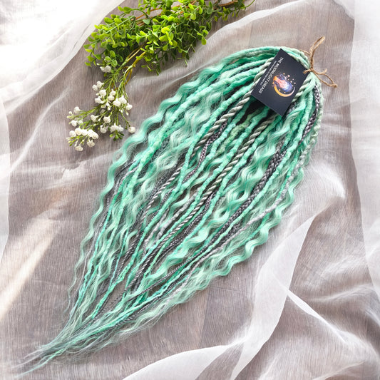 Silver Mint: soft, lightweight, and reusable 20 double ended synthetic crochet dreadlocks, braids, and non-brushable curls in a soft blend of silver and aquamarine.
