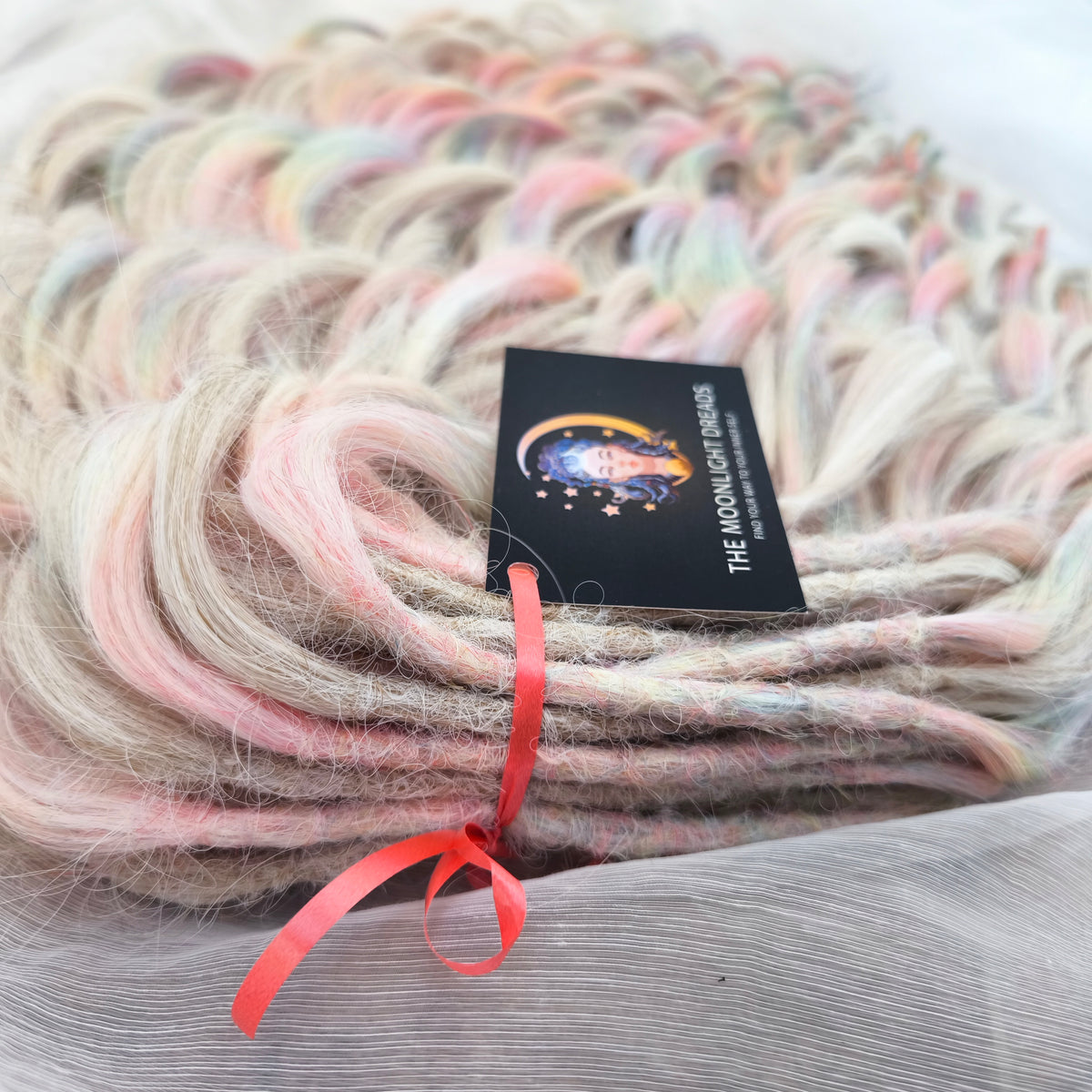 Fairy Dust - 50 DE soft, lightweight, and reusable synthetic standard dreaded brushable curls. A mix of platinum blonde and pastel rainbow/prism