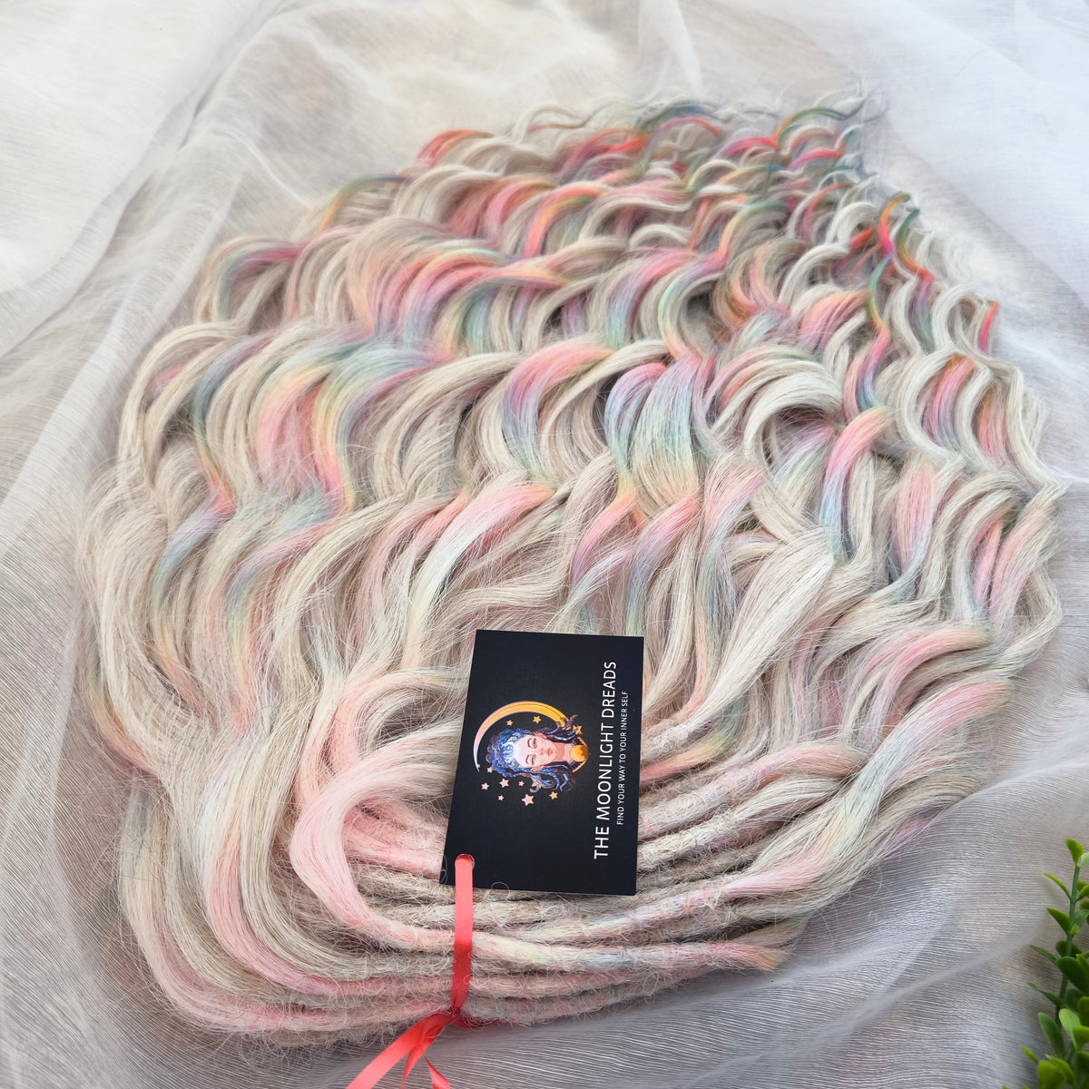 Fairy Dust - 50 DE soft, lightweight, and reusable synthetic standard dreaded brushable curls. A mix of platinum blonde and pastel rainbow/prism