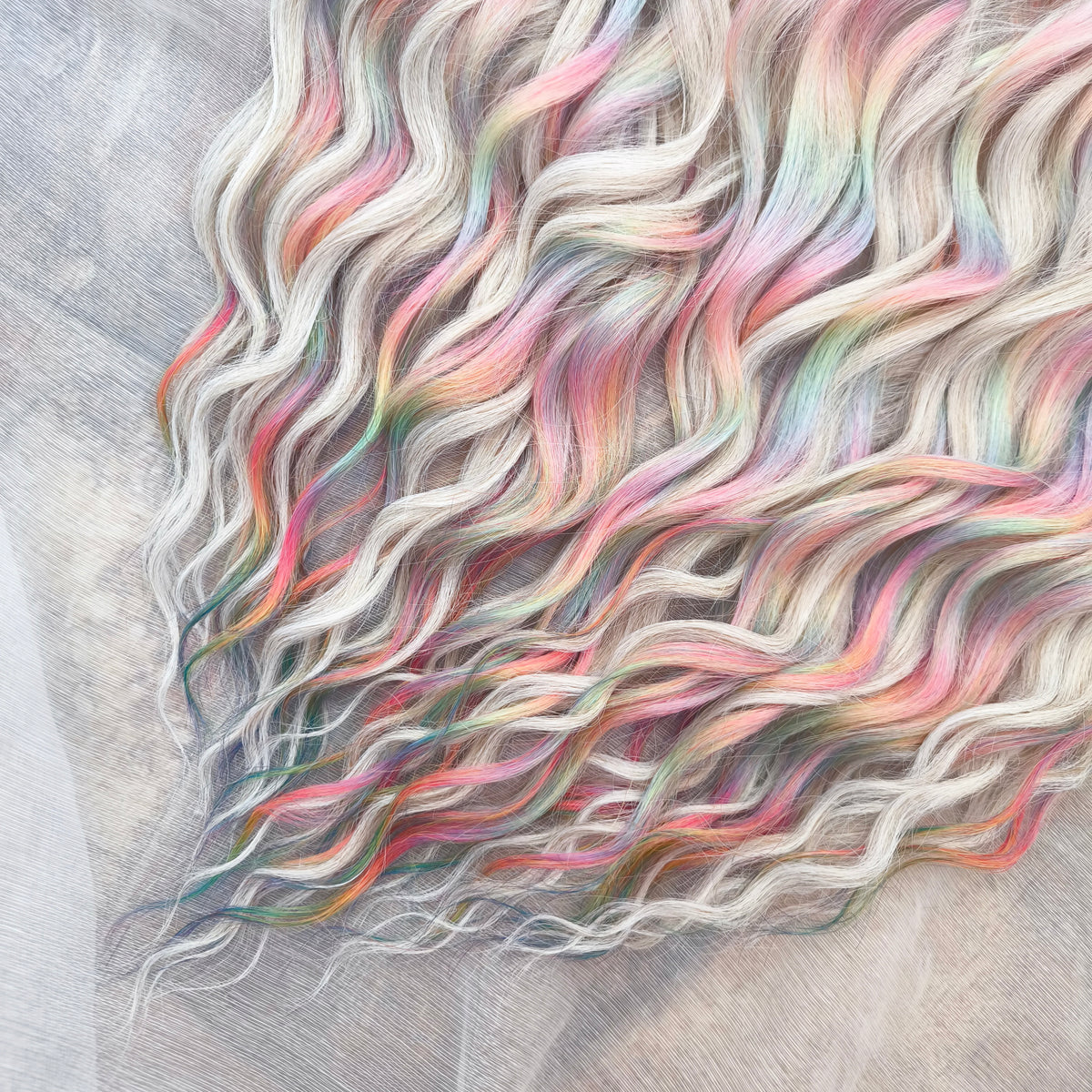 Fairy Dust - 50 DE soft, lightweight, and reusable synthetic standard dreaded brushable curls. A mix of platinum blonde and pastel rainbow/prism