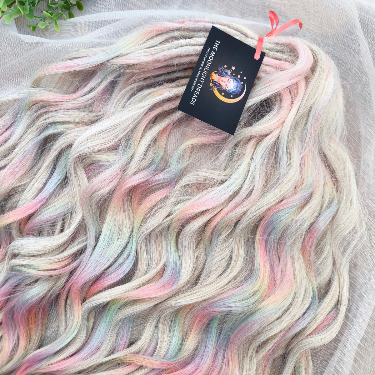 Fairy Dust - 50 DE soft, lightweight, and reusable synthetic standard dreaded brushable curls. A mix of platinum blonde and pastel rainbow/prism