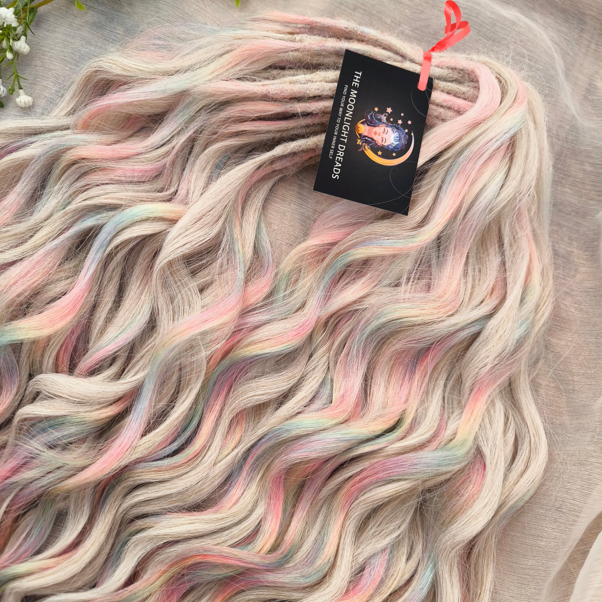 Fairy Dust - 50 DE soft, lightweight, and reusable synthetic standard dreaded brushable curls. A mix of platinum blonde and pastel rainbow/prism