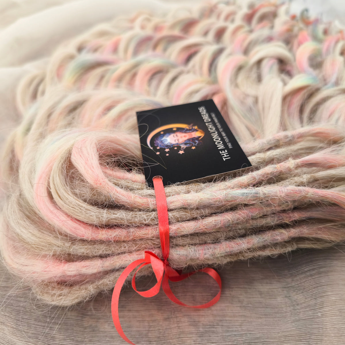 Fairy Dust - 50 DE soft, lightweight, and reusable synthetic standard dreaded brushable curls. A mix of platinum blonde and pastel rainbow/prism