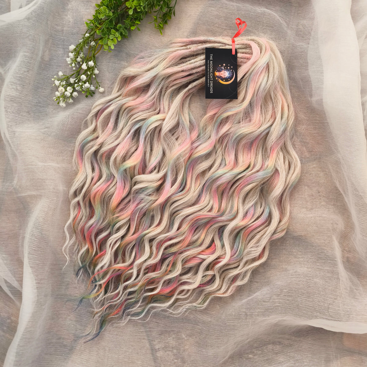 Fairy Dust - 50 DE soft, lightweight, and reusable synthetic standard dreaded brushable curls. A mix of platinum blonde and pastel rainbow/prism