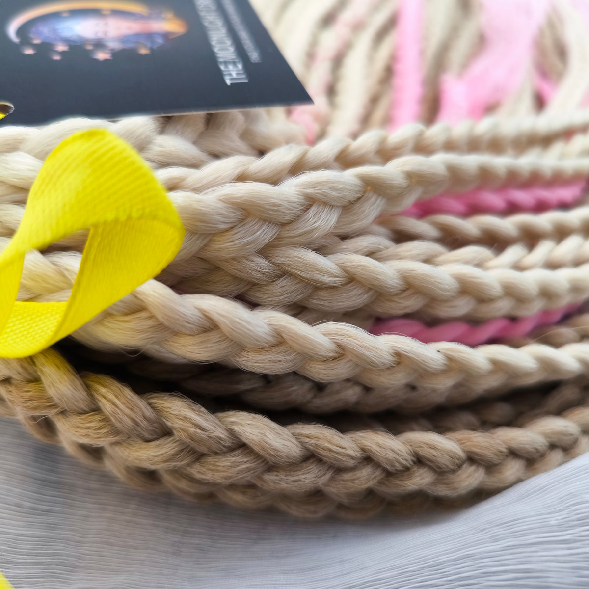 Vanilla Rose - a soft, lightweight, and reusable set of DE synthetic braids in creamy vanilla blonde, beige, and soft pink shades