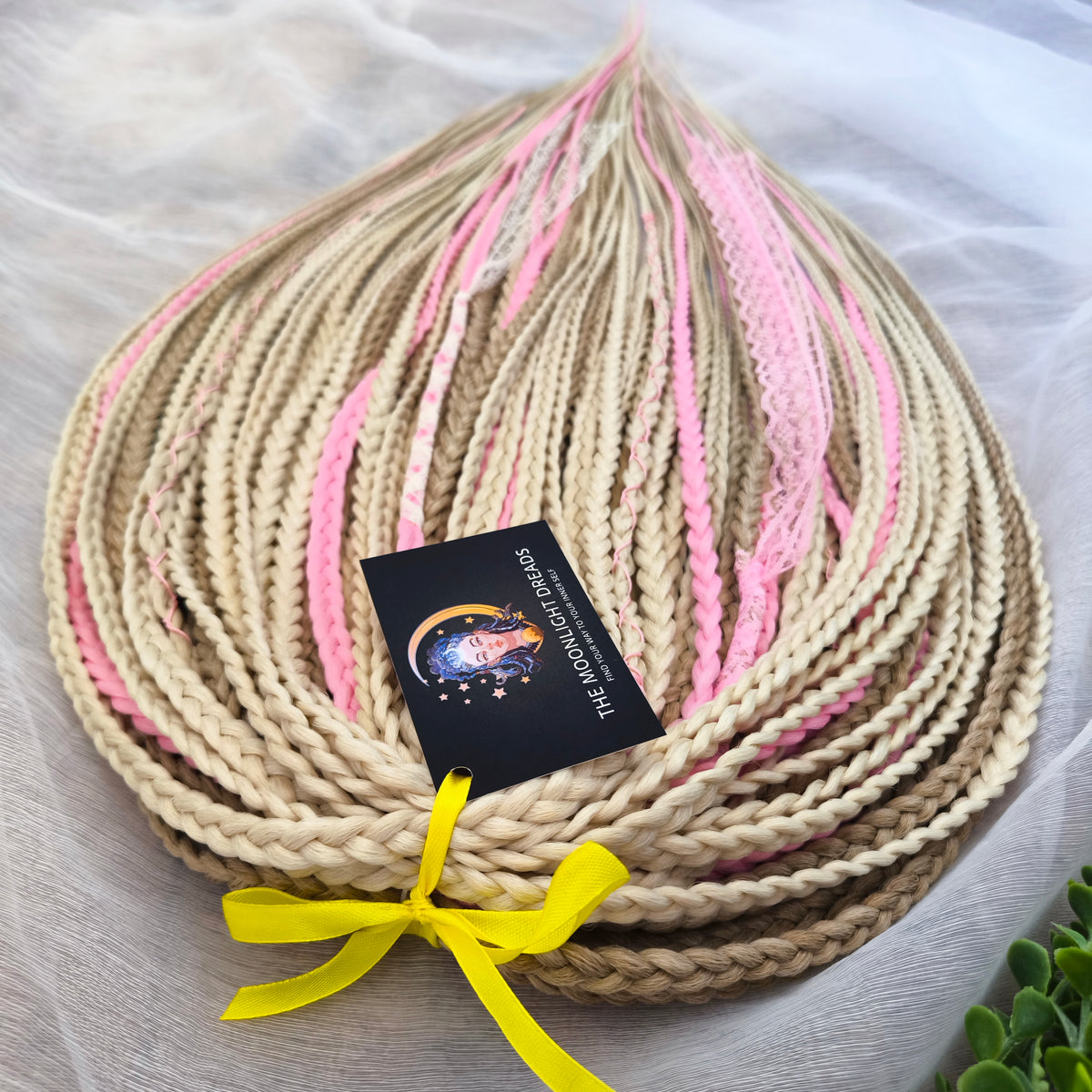 Vanilla Rose - a soft, lightweight, and reusable set of DE synthetic braids in creamy vanilla blonde, beige, and soft pink shades