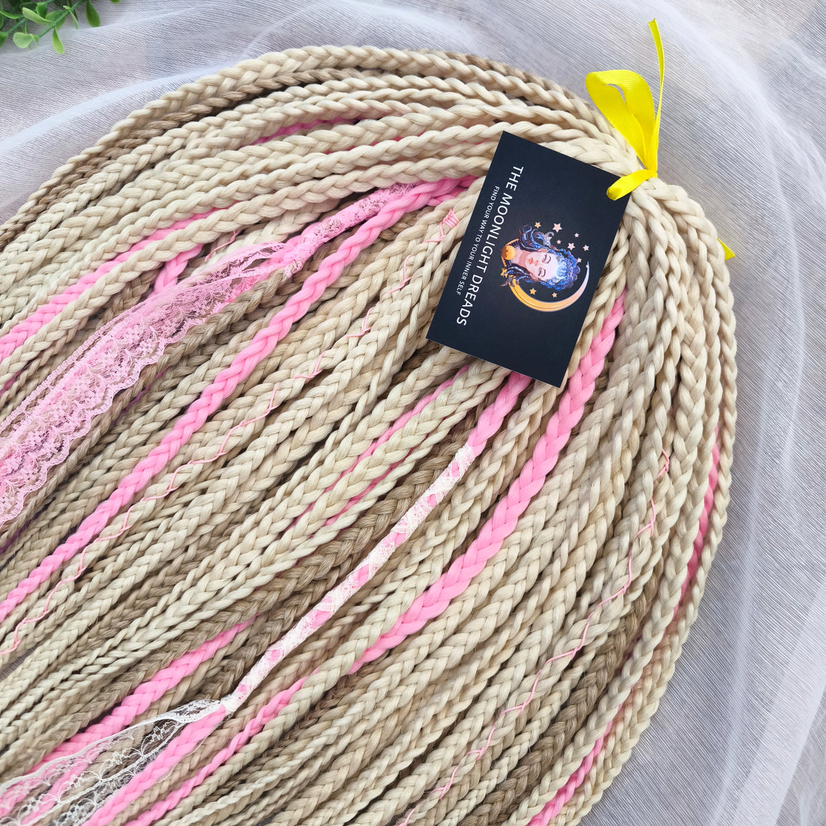 Vanilla Rose - a soft, lightweight, and reusable set of DE synthetic braids in creamy vanilla blonde, beige, and soft pink shades