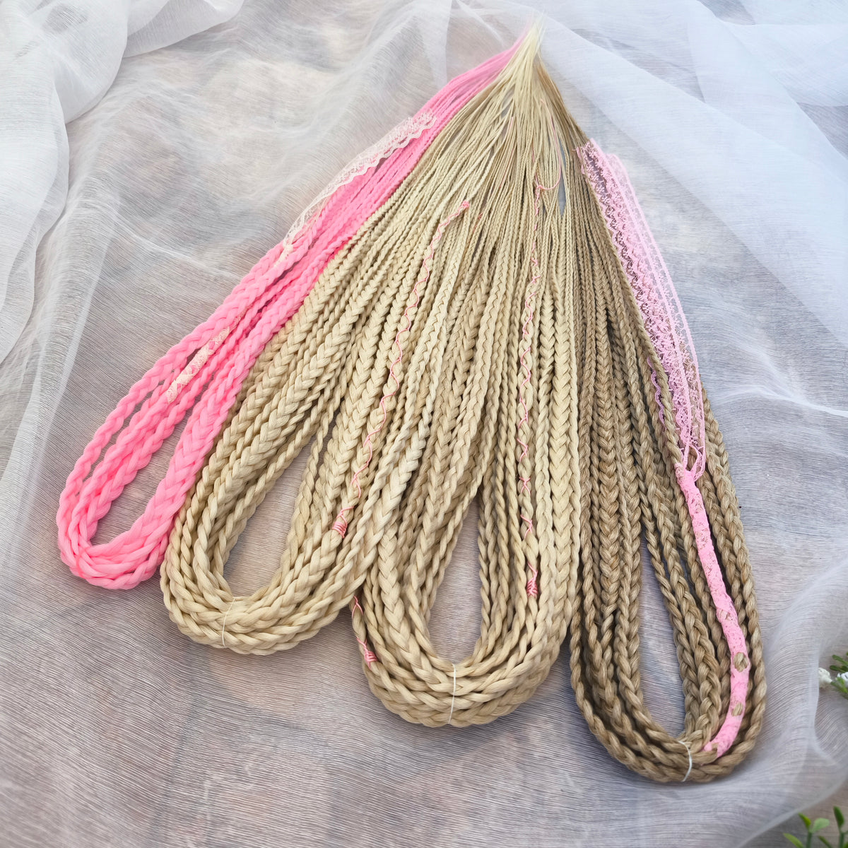Vanilla Rose - a soft, lightweight, and reusable set of DE synthetic braids in creamy vanilla blonde, beige, and soft pink shades