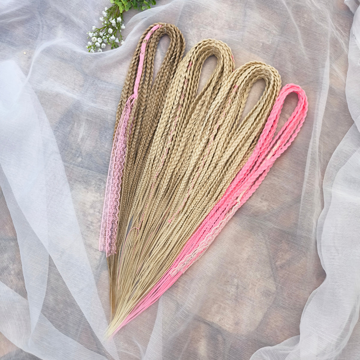 Vanilla Rose - a soft, lightweight, and reusable set of DE synthetic braids in creamy vanilla blonde, beige, and soft pink shades