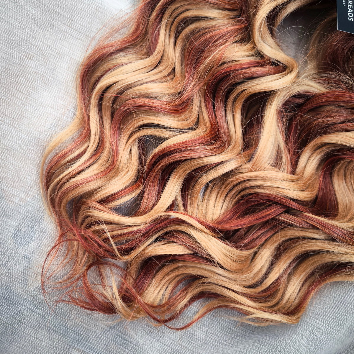 Copper Honey - 60 DE soft, lightweight, and reusable synthetic standard dreaded brushable curls Manasi. Peach blonde base mixed with copper red.