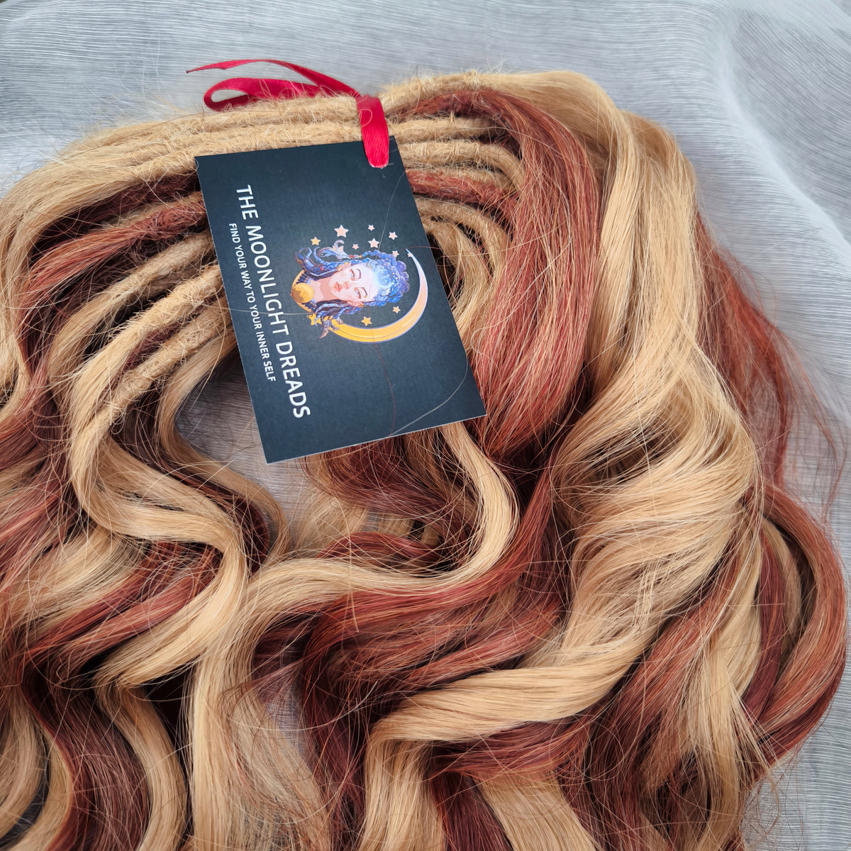 Copper Honey - 60 DE soft, lightweight, and reusable synthetic standard dreaded brushable curls Manasi. Peach blonde base mixed with copper red.