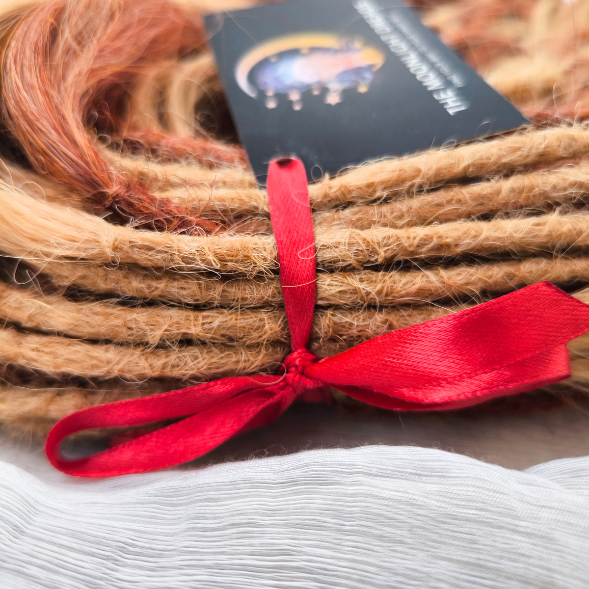 Copper Honey - 60 DE soft, lightweight, and reusable synthetic standard dreaded brushable curls Manasi. Peach blonde base mixed with copper red.