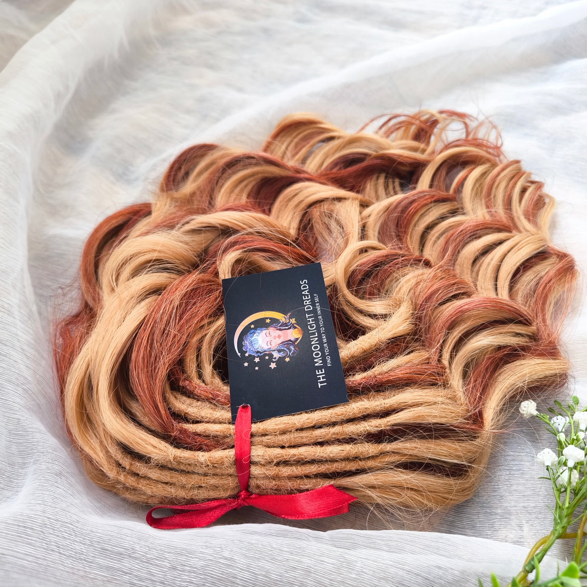 Copper Honey - 60 DE soft, lightweight, and reusable synthetic standard dreaded brushable curls Manasi. Peach blonde base mixed with copper red.