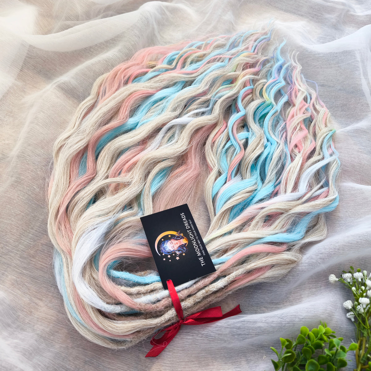 Second Life: Cotton Candy - 50 DE synthetic regular dreaded brushable curls (one-side dreaded part). A blend of platinum blonde, sky blue, pink, and rainbow colors.  Worn once . Has been washed and corrected. Good condition (a bit damaged ends).