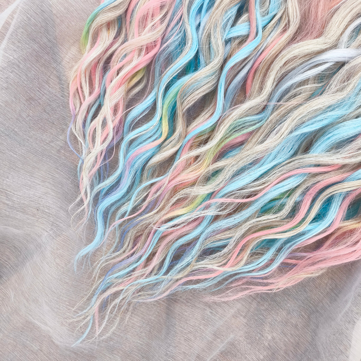 Second Life: Cotton Candy - 50 DE synthetic regular dreaded brushable curls (one-side dreaded part). A blend of platinum blonde, sky blue, pink, and rainbow colors.  Worn once . Has been washed and corrected. Good condition (a bit damaged ends).