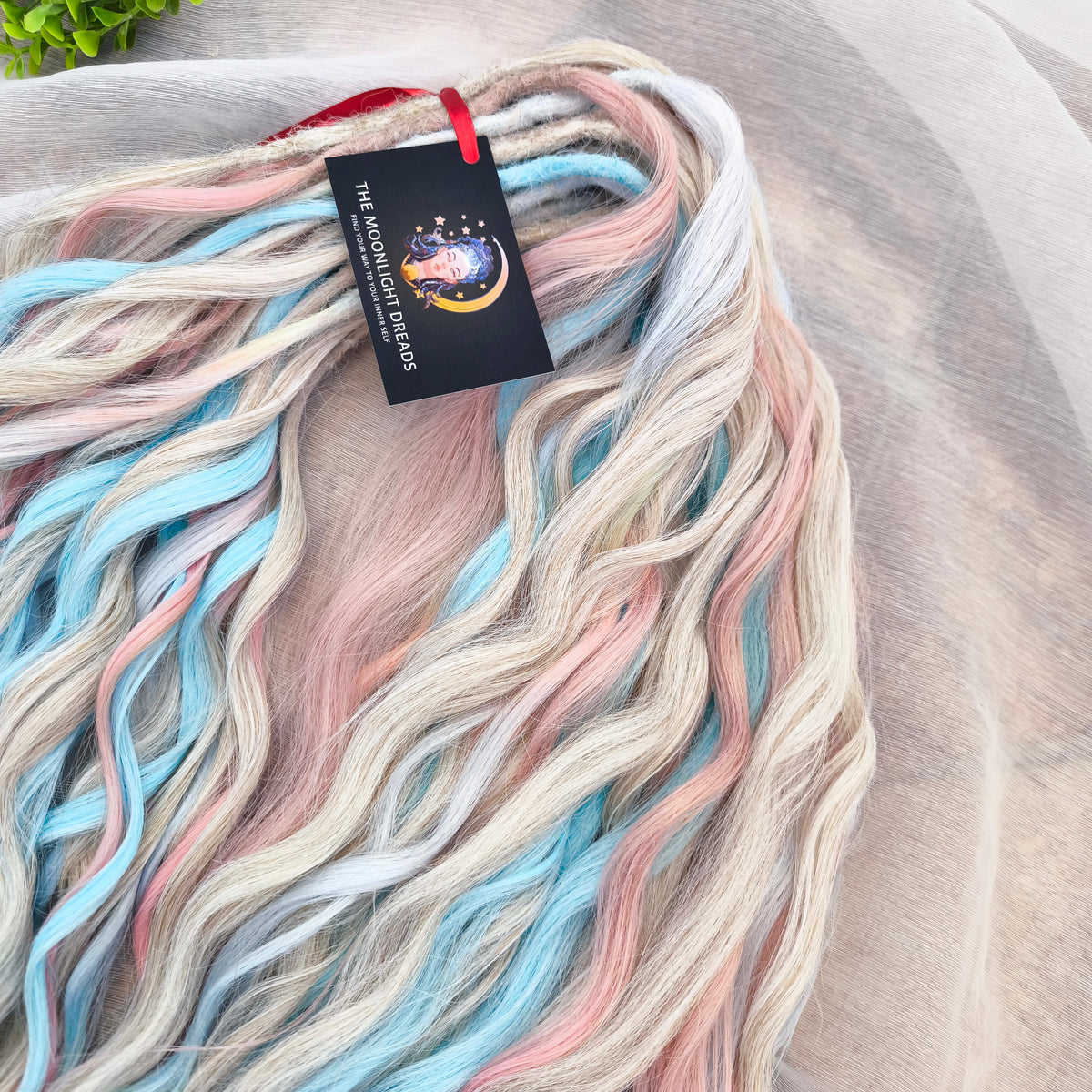 Second Life: Cotton Candy - 50 DE synthetic regular dreaded brushable curls (one-side dreaded part). A blend of platinum blonde, sky blue, pink, and rainbow colors.  Worn once . Has been washed and corrected. Good condition (a bit damaged ends).