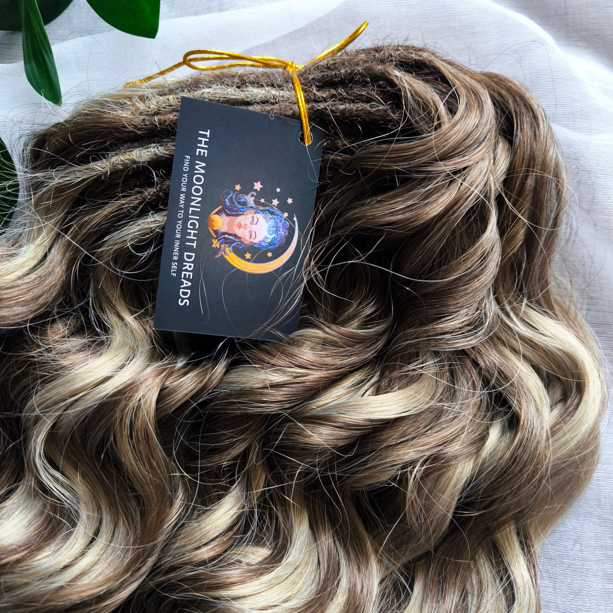 Ash Browny - 60 DE soft, lightweight, and reusable synthetic standard dreaded brushable curls Manasi. A mix of ash wheat blonde with dark chocolate brown roots and brown