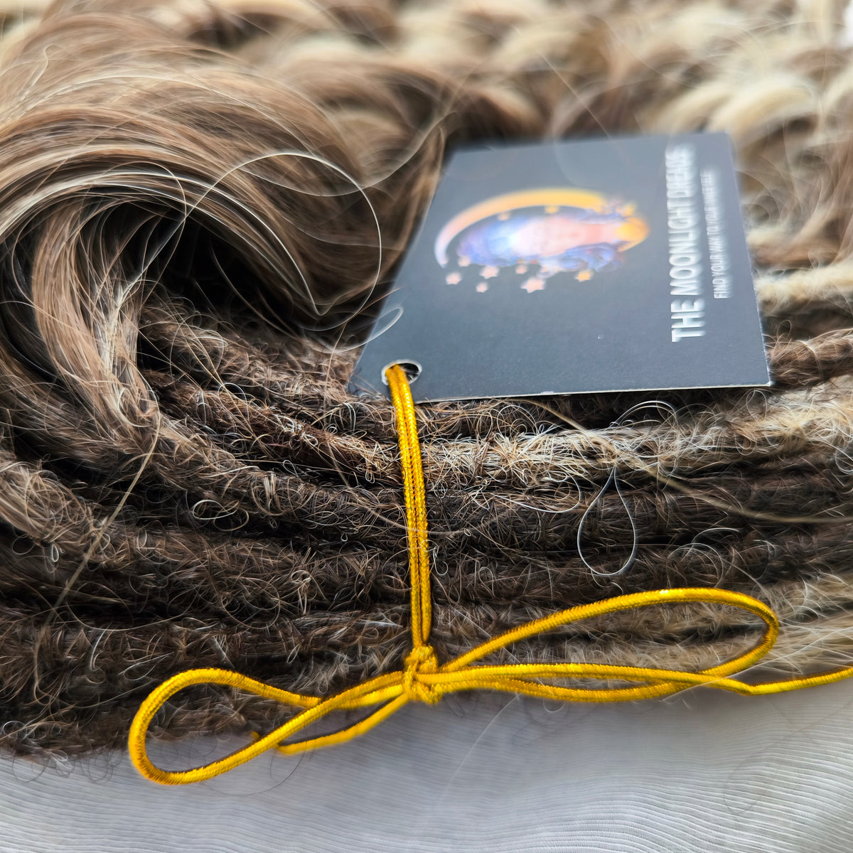 Ash Browny - 60 DE soft, lightweight, and reusable synthetic standard dreaded brushable curls Manasi. A mix of ash wheat blonde with dark chocolate brown roots and brown