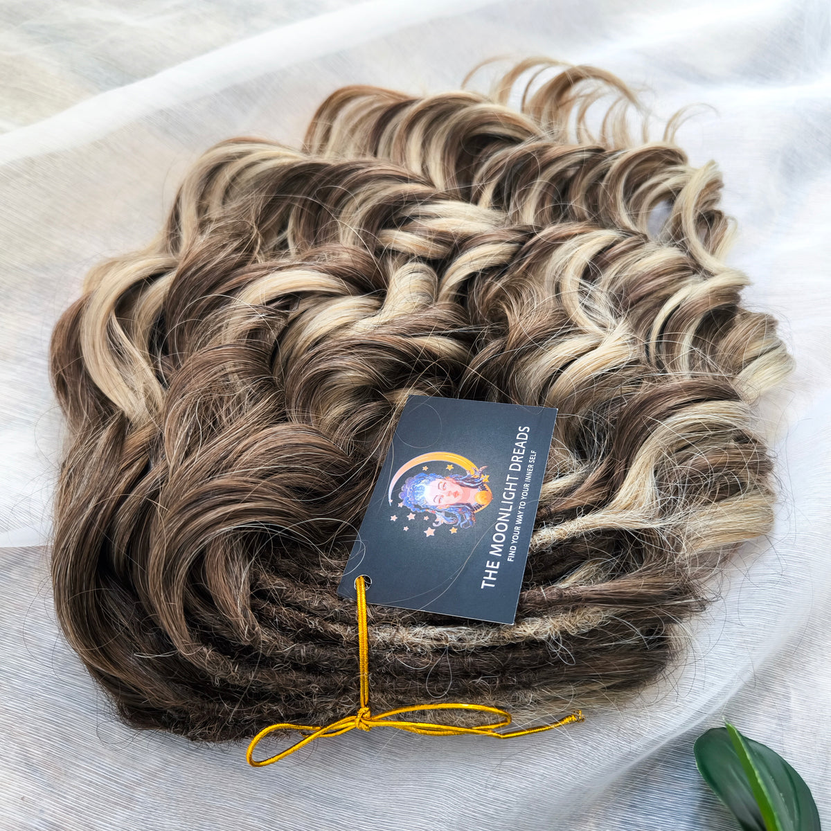 Ash Browny - 60 DE soft, lightweight, and reusable synthetic standard dreaded brushable curls Manasi. A mix of ash wheat blonde with dark chocolate brown roots and brown