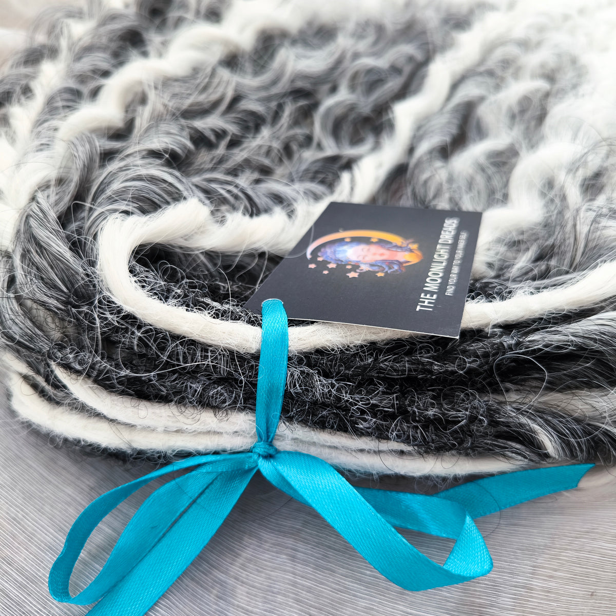 mix of ombre from grey to white and snow white, lightweight, and reusable double ended synthetic standard dreaded non-brushable curls