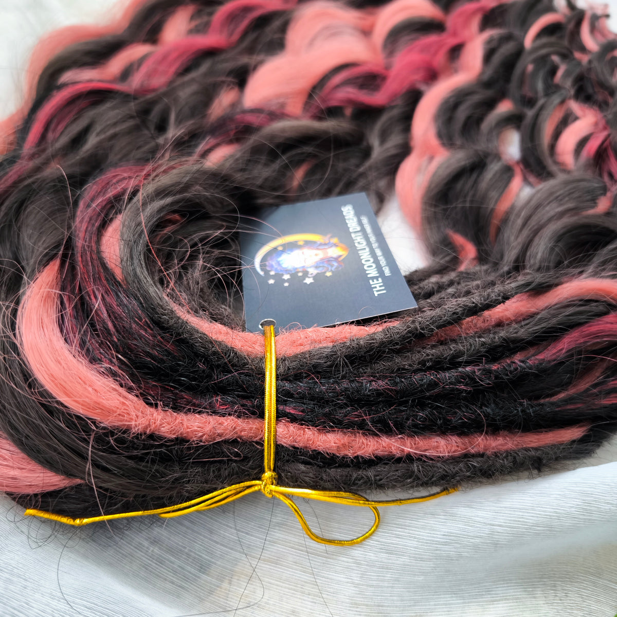 Rosewood - a soft, lightweight, and reusable set of double ended wavy dreadlocks in dark chocolate brown, dusty rose pink, and bordo shades. A rich, warm blend with a subtle romantic touch.
