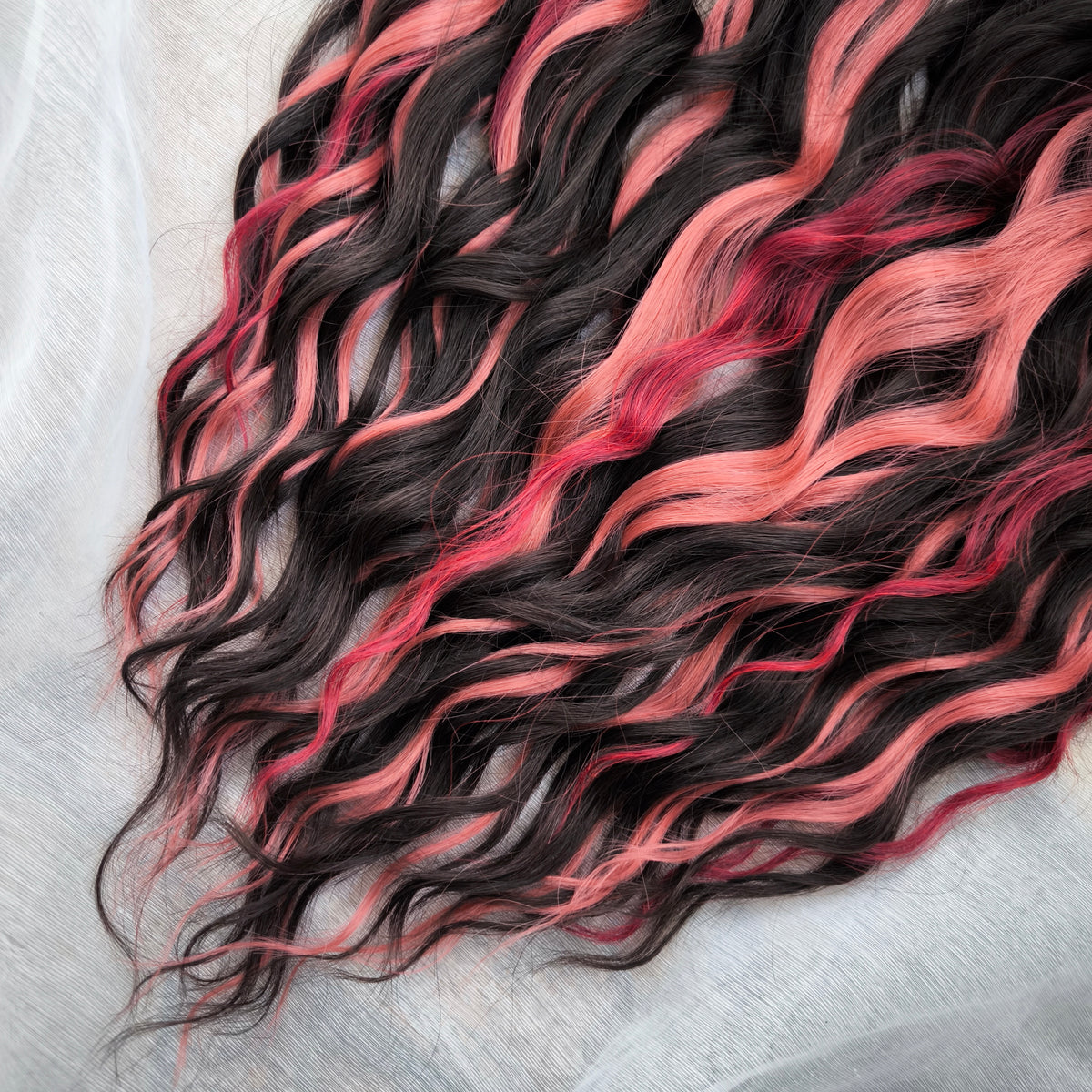 Rosewood - a soft, lightweight, and reusable set of double ended wavy dreadlocks in dark chocolate brown, dusty rose pink, and bordo shades. A rich, warm blend with a subtle romantic touch.