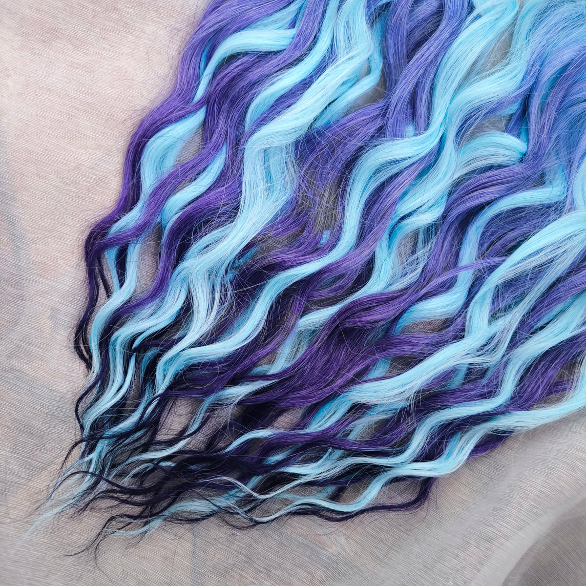 Blue Iris - soft, lightweight, and reusable; this set combines purple, cool blue, and deep navy brushable, synthetic double ended wavy dreadlocks.
