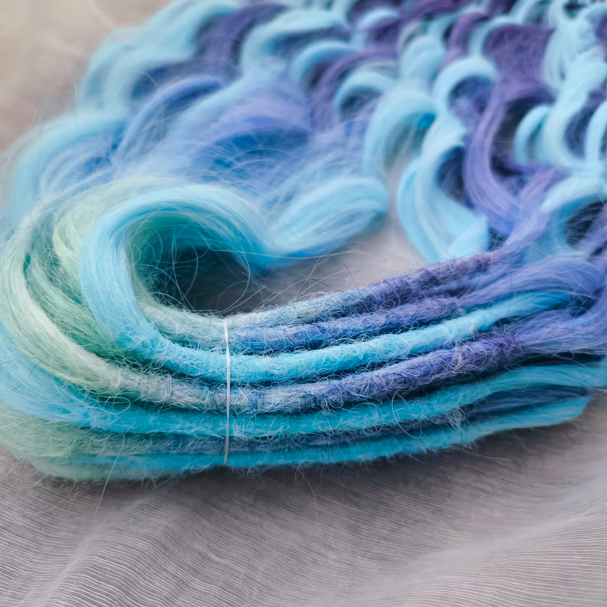 Blue Iris - soft, lightweight, and reusable; this set combines purple, cool blue, and deep navy brushable, synthetic double ended wavy dreadlocks.

