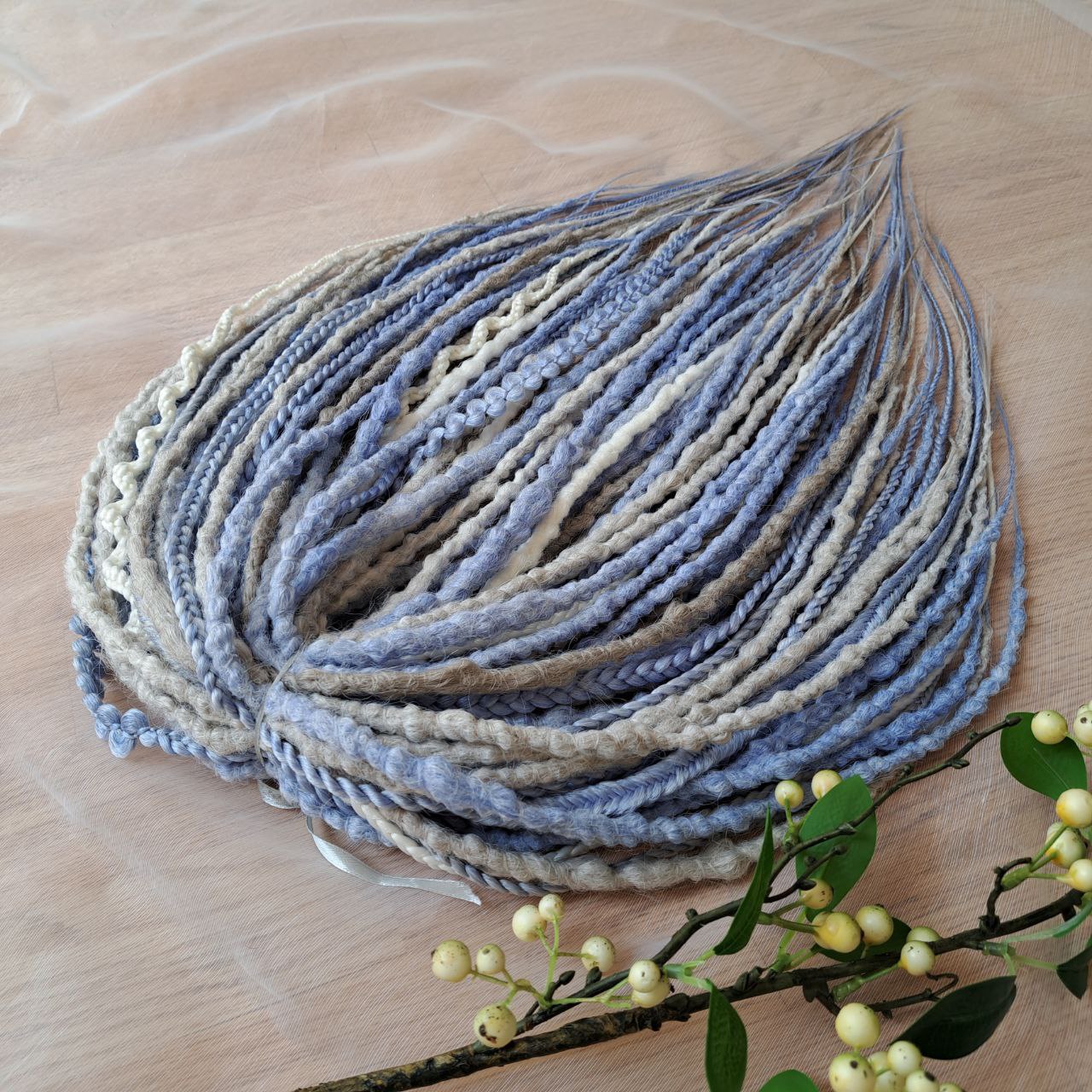 Soft, lightweight, and reusable 52 double ended synthetic bumpy dreadlocks &nbsp;and braids. This set combines soft ash-grey, muted ice blue, and pale cream shades. This cool-toned palette creates a calm, sophisticated look with a hint of coastal breeze and winter frost.

Length: 21 inches (≈53 cm)
Thickness of dreads and braids: ≈0.8-1 cm
Weight: 430 gr (≈15 oz)