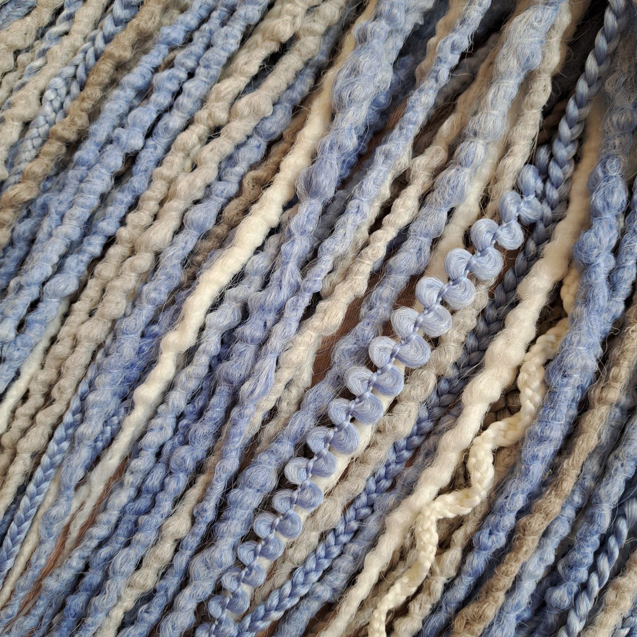 Soft, lightweight, and reusable 52 double ended synthetic bumpy dreadlocks &nbsp;and braids. This set combines soft ash-grey, muted ice blue, and pale cream shades. This cool-toned palette creates a calm, sophisticated look with a hint of coastal breeze and winter frost.

Length: 21 inches (≈53 cm)
Thickness of dreads and braids: ≈0.8-1 cm
Weight: 430 gr (≈15 oz)