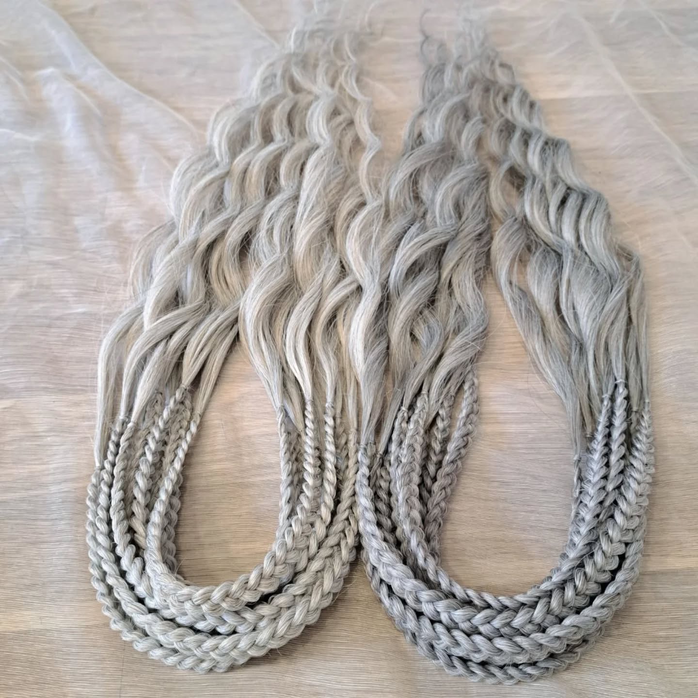 Soft, lightweight, and reusable synthetic brushable double ended wavy dreadlocks (regular dreaded, braided middle, or push-up) in 2 shades of gray.