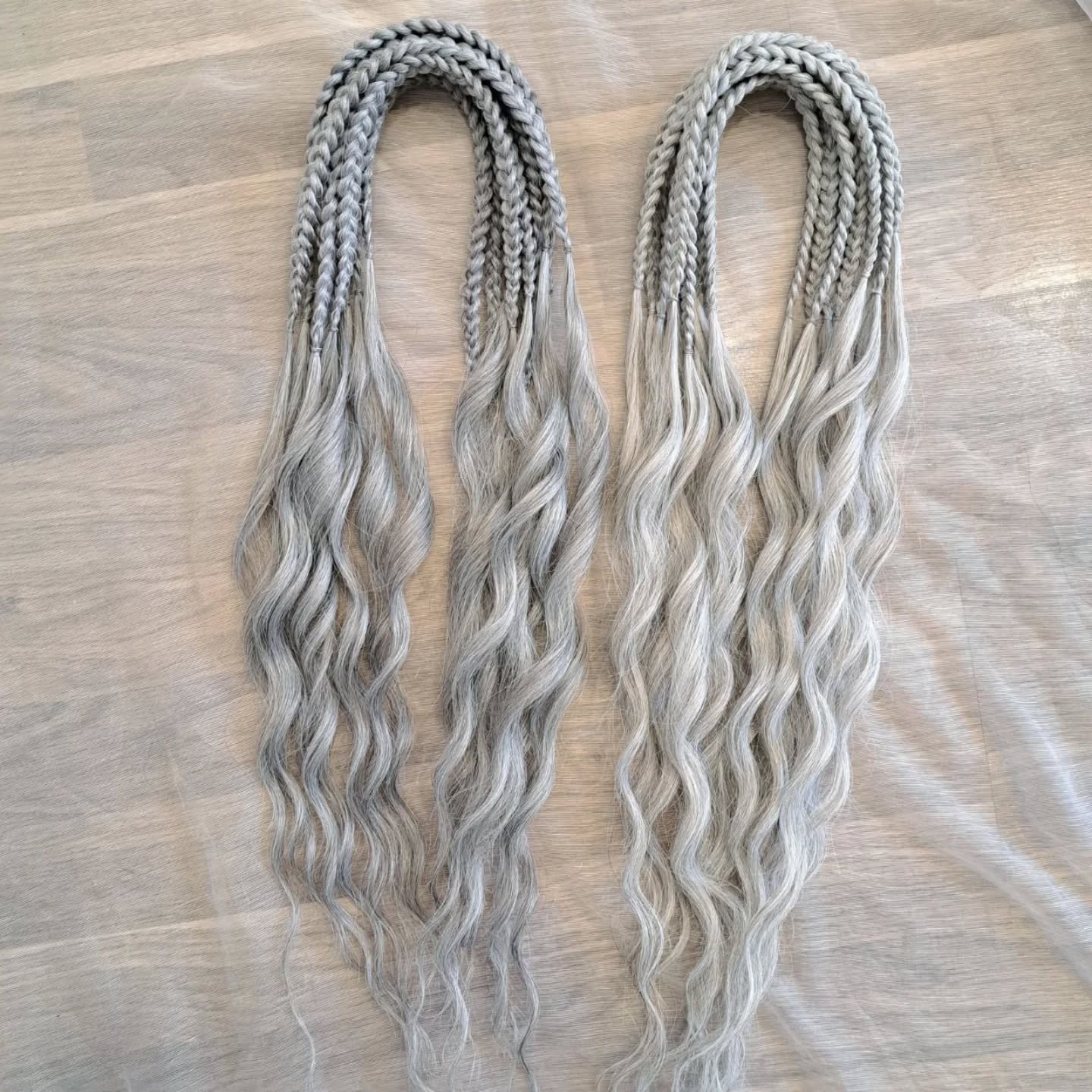 Soft, lightweight, and reusable synthetic brushable double ended wavy dreadlocks (regular dreaded, braided middle, or push-up) in 2 shades of gray.