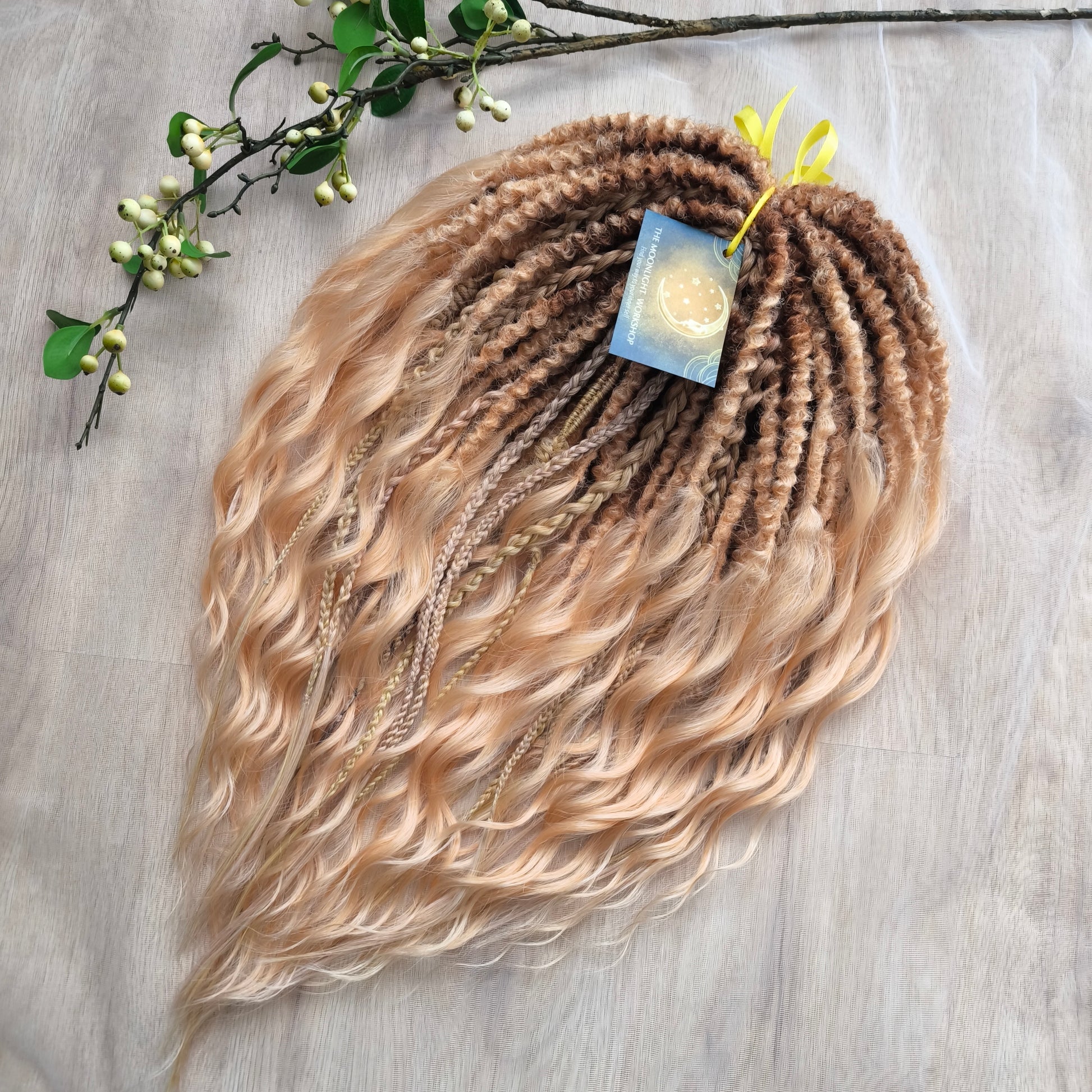 Soft, lightweight, and reusable synthetic brushable double ended wavy dreadlocks. The base starts with a warm chocolate chestnut at the roots, blending seamlessly into a sandy honey blonde with subtle creamy peach undertones. 