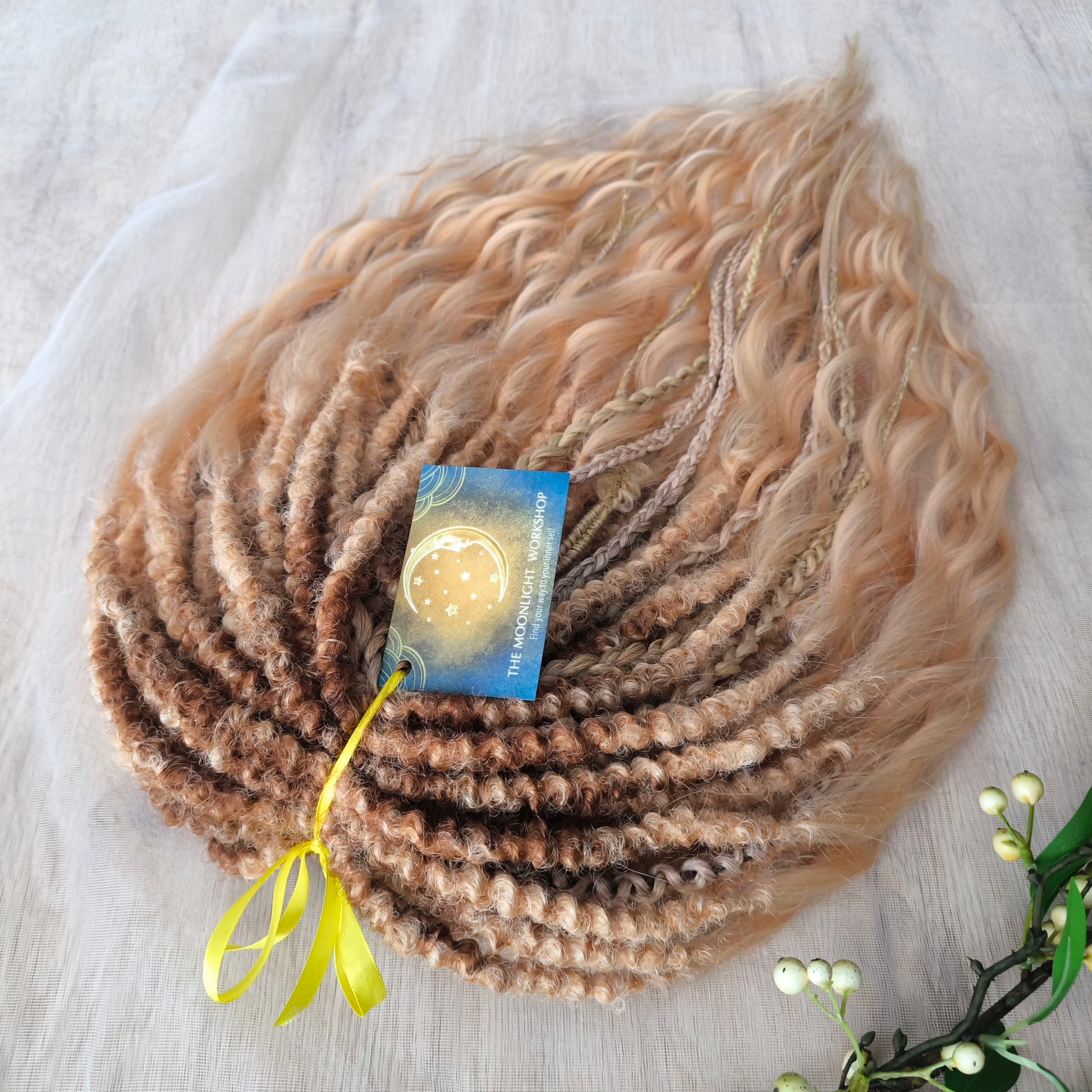 Soft, lightweight, and reusable synthetic brushable double ended wavy dreadlocks. The base starts with a warm chocolate chestnut at the roots, blending seamlessly into a sandy honey blonde with subtle creamy peach undertones. 