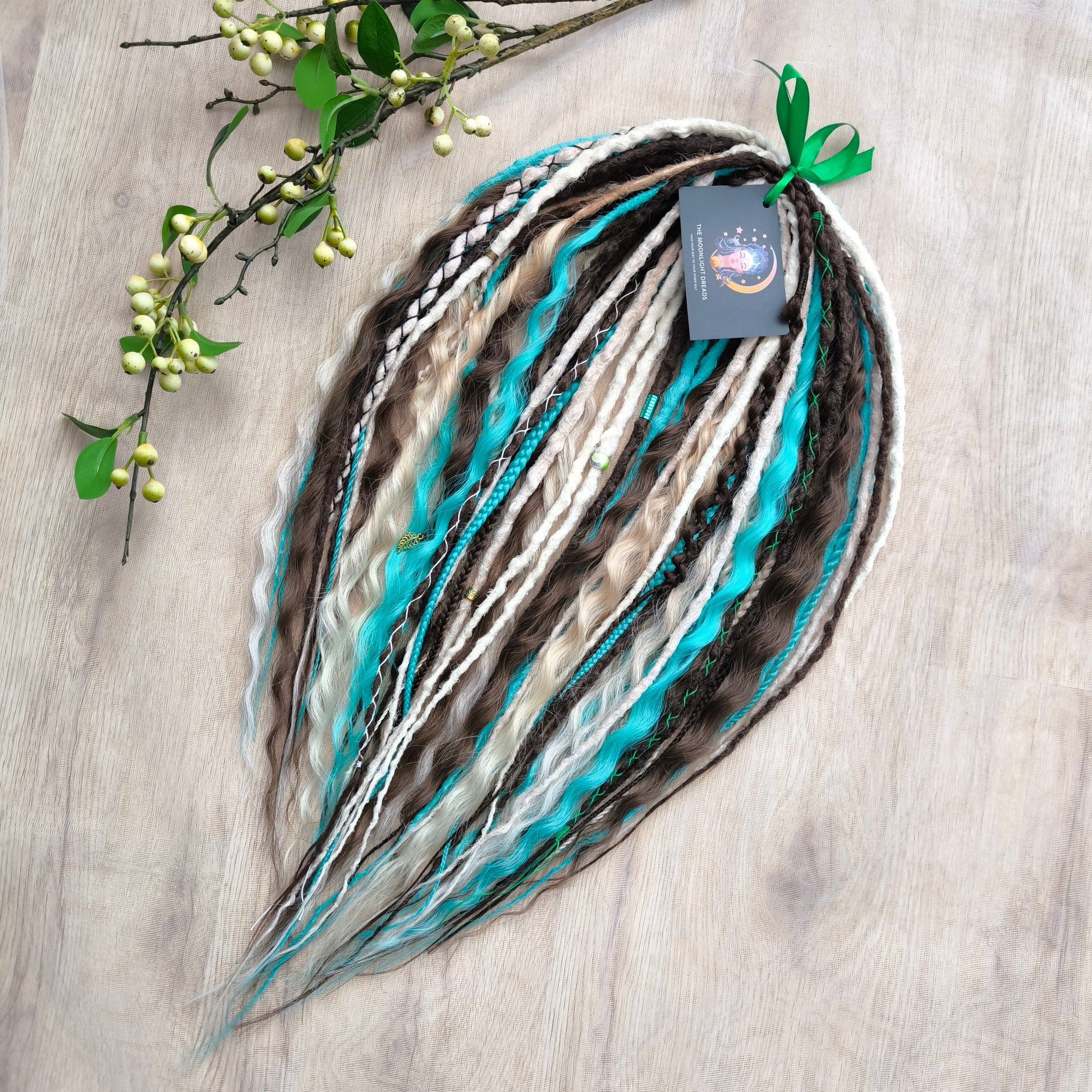 Brown, 2 shades of blonde, and turquoise green soft, lightweight, and reusable synthetic dreads, braids, and regular dreaded non-brushable curls (colors based on the Arctic Mocha brushable curls set)

The length is 22-24 inches (55-60 cm)
Dreaded part of curls: 4-5 inches
Thickness of braids ±0.8 cm